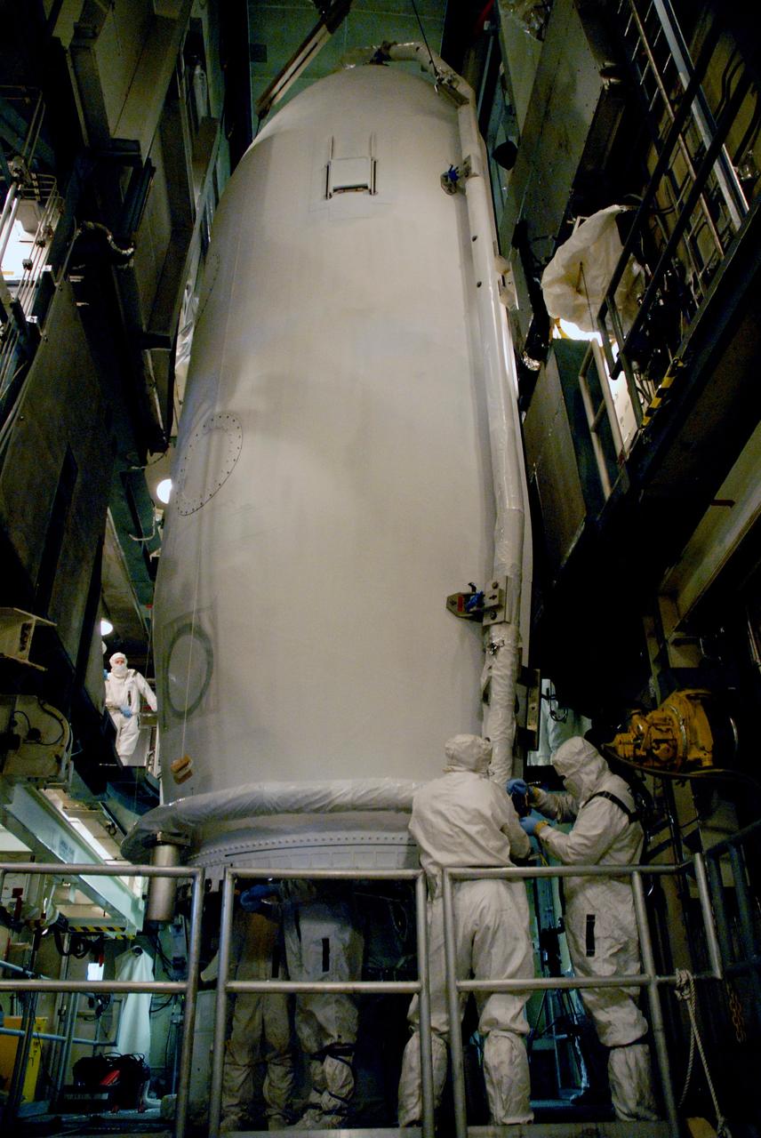 CAPE CANAVERAL, Fla. – Inside the mobile service tower on Launch Pad 17-B at Cape Canaveral Air Force Station in Florida, the second half of the fairing is being moved toward the Space Tracking and Surveillance System – Demonstrator spacecraft. The fairing is a two-part molded structure that fits flush with the outside surface of the rocket and forms an aerodynamically smooth nose cone, protecting the spacecraft during launch and ascent.  STSS Demo is a space-based sensor component of a layered Ballistic Missile Defense System designed for the overall mission of detection, tracking and discriminating ballistic missiles.  STSS is capable of tracking objects after boost phase and provides trajectory information to other sensors. It will be launched by NASA for the Missile Defense Agency between 8 and 8:58 a.m. EDT Sept. 18. Approved for Public Release 09-MDA-4934 (09-22-09) Photo credit: NASA/Cory Huston