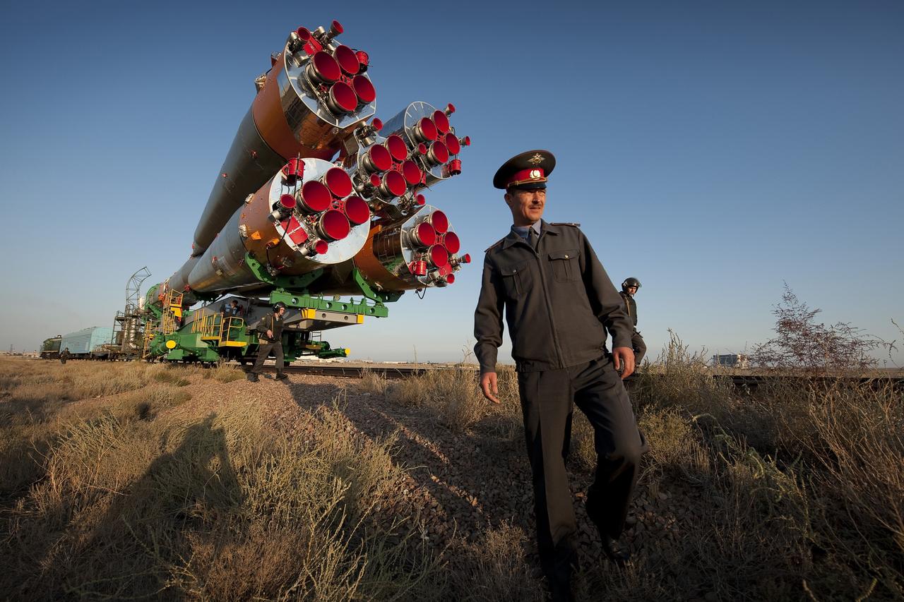 KAZAKHSTAN -- Russian security officers walk along the railroad tracks as the Soyuz rocket is rolled out to the launch pad Monday, Sept. 28, 2009 at the Baikonur Cosmodrome in Kazakhstan.  The Soyuz is scheduled to launch the crew of Expedition 21 and a spaceflight participant on Sept. 30, 2009.  Photo Credit: (NASA/Bill Ingalls)