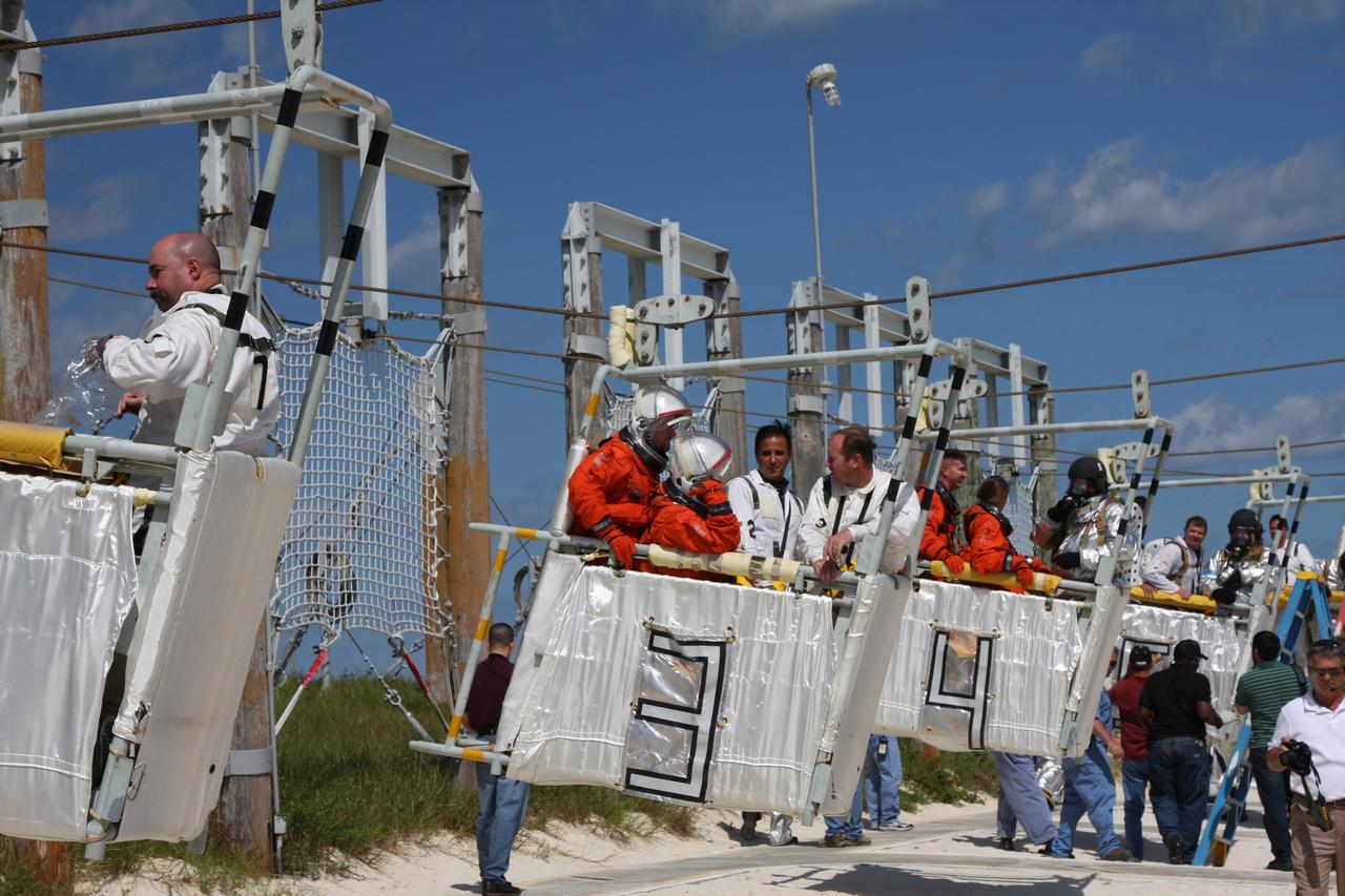 CAPE CANAVERAL, Fla. –  At the Launch Pad 39A slidewire basket landing site at NASA's Kennedy Space Center in Florida, a Mode II-IV exercise is underway, involving NASA fire rescue personnel, volunteers portraying astronauts with simulated injuries, helicopters and personnel from the Air Force’s 920th Rescue Wing and medical trauma teams at three central Florida hospitals.  The drill allows teams to practice an emergency response at Pad 39A, including helicopter evacuation to local hospitals. The Space Shuttle Program and U.S. Air Force are conducting the emergency simulation.  Photo credit: NASA/Dimitri Gerondidakis