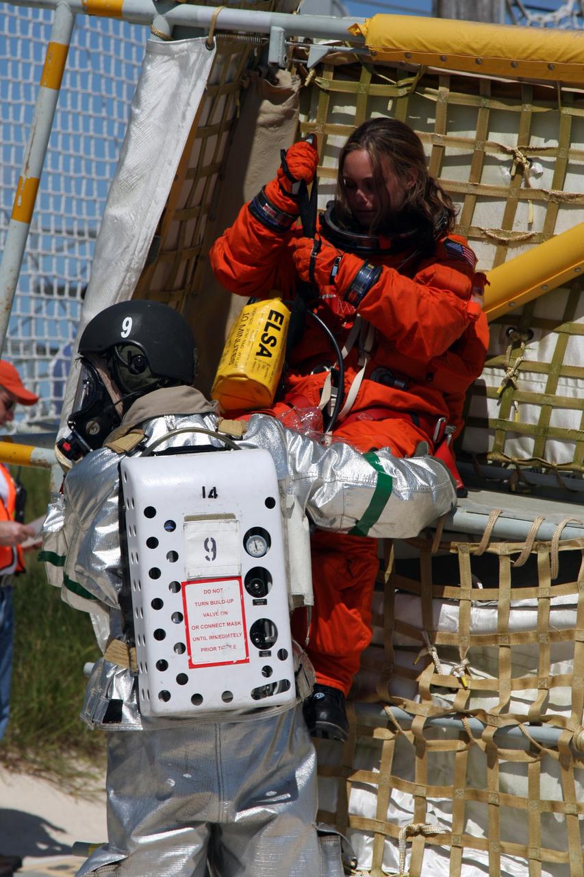 CAPE CANAVERAL, Fla. –  At the Launch Pad 39A slidewire basket landing site at NASA's Kennedy Space Center in Florida, a Mode II-IV exercise is underway, involving NASA fire rescue personnel, volunteers portraying astronauts with simulated injuries, helicopters and personnel from the Air Force’s 920th Rescue Wing and medical trauma teams at three central Florida hospitals.  The drill allows teams to practice an emergency response at Pad 39A, including helicopter evacuation to local hospitals. The Space Shuttle Program and U.S. Air Force are conducting the emergency simulation.  Photo credit: NASA/Dimitri Gerondidakis