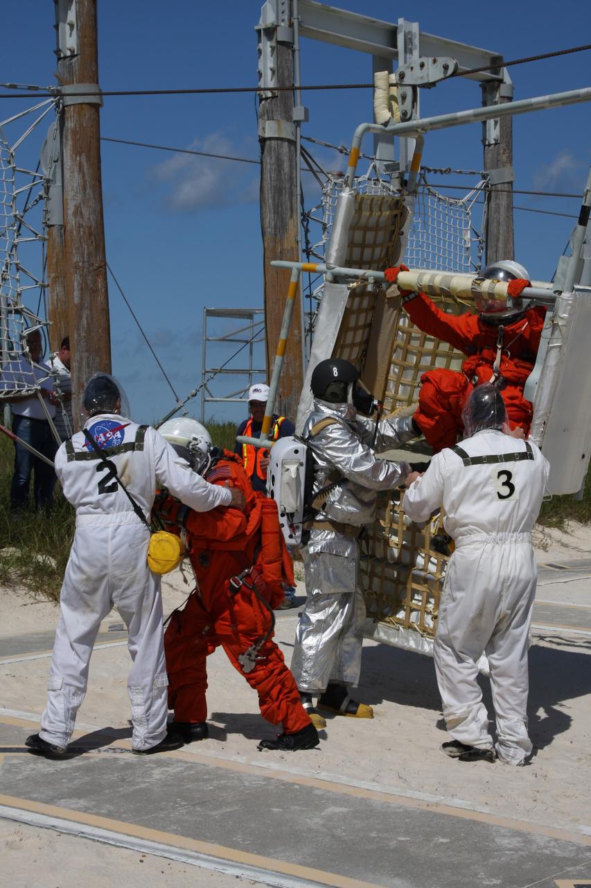 CAPE CANAVERAL, Fla. –  At the Launch Pad 39A slidewire basket landing site at NASA's Kennedy Space Center in Florida, a Mode II-IV exercise is underway, involving NASA fire rescue personnel, volunteers portraying astronauts with simulated injuries, helicopters and personnel from the Air Force’s 920th Rescue Wing and medical trauma teams at three central Florida hospitals. The drill allows teams to practice an emergency response at Pad 39A, including helicopter evacuation to local hospitals. The Space Shuttle Program and U.S. Air Force are conducting the emergency simulation.  Photo credit: NASA/Dimitri Gerondidakis