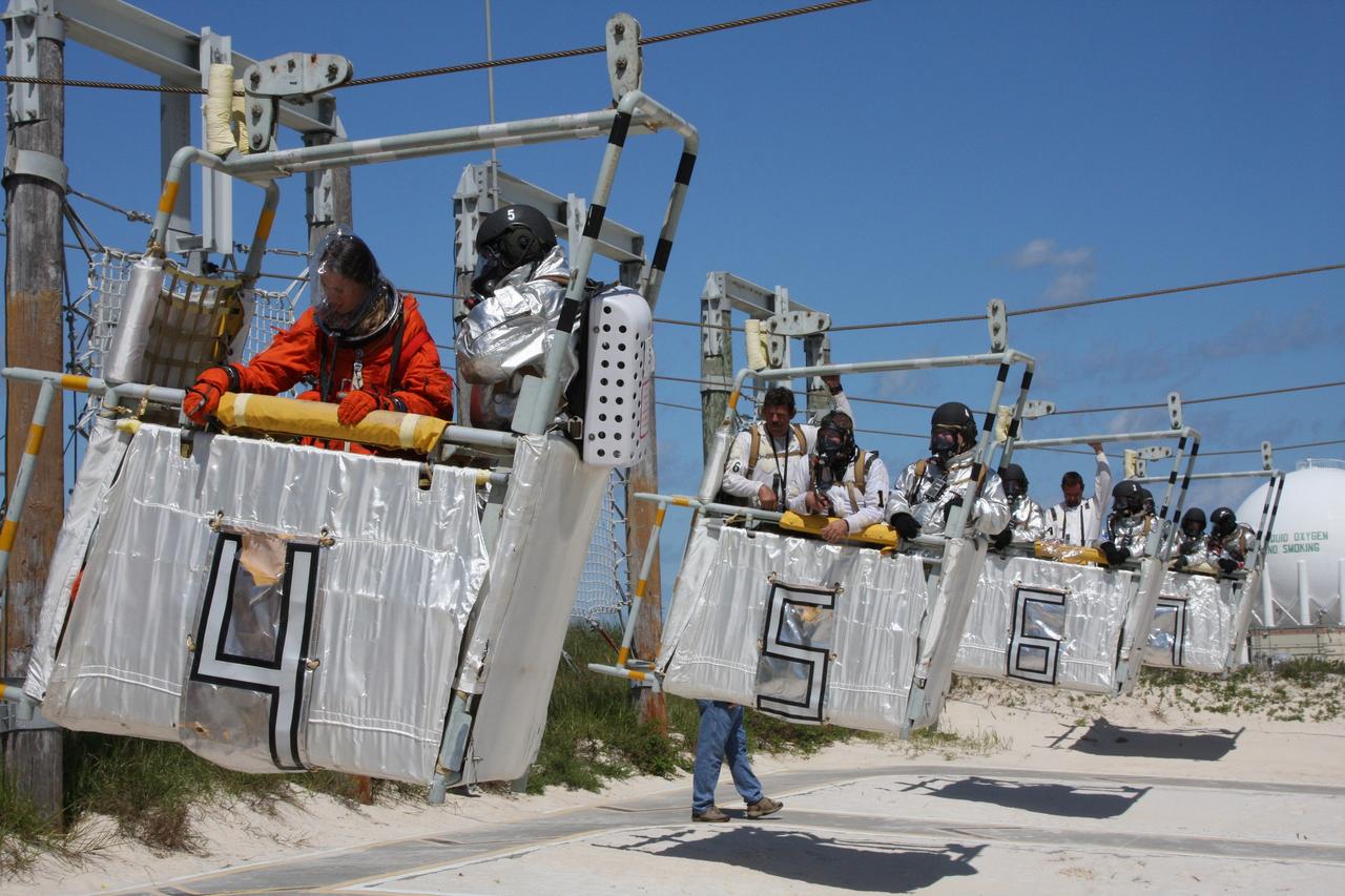 CAPE CANAVERAL, Fla. –  At the Launch Pad 39A slidewire basket landing site at NASA's Kennedy Space Center in Florida, a Mode II-IV exercise is underway, involving NASA fire rescue personnel, volunteers portraying astronauts with simulated injuries, helicopters and personnel from the Air Force’s 920th Rescue Wing and medical trauma teams at three central Florida hospitals.  The drill allows teams to practice an emergency response at Pad 39A, including helicopter evacuation to local hospitals. The Space Shuttle Program and U.S. Air Force are conducting the emergency simulation.  Photo credit: NASA/Dimitri Gerondidakis