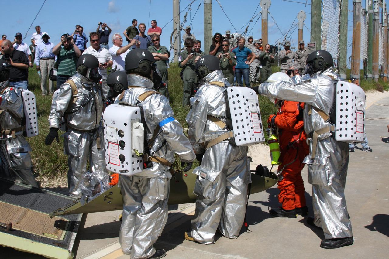 CAPE CANAVERAL, Fla. –  At the Launch Pad 39A slidewire basket landing site at NASA's Kennedy Space Center in Florida, a Mode II-IV exercise is underway, involving NASA fire rescue personnel, volunteers portraying astronauts with simulated injuries, helicopters and personnel from the Air Force’s 920th Rescue Wing and medical trauma teams at three central Florida hospitals.  The drill allows teams to practice an emergency response at Pad 39A, including helicopter evacuation to local hospitals. The Space Shuttle Program and U.S. Air Force are conducting the emergency simulation.  Photo credit: NASA/Dimitri Gerondidakis