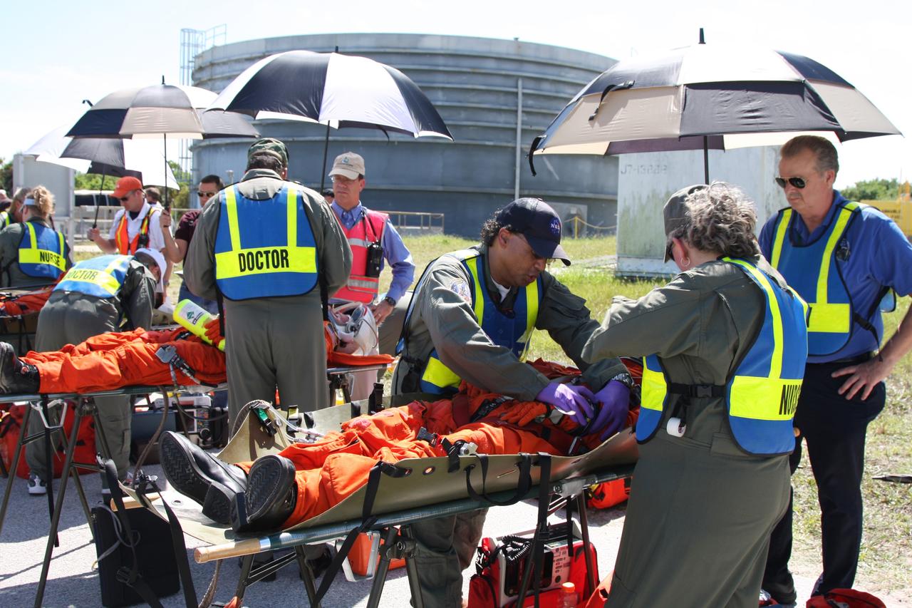 CAPE CANAVERAL, Fla. – At NASA's Kennedy Space Center in Florida, a Mode II-IV exercise is underway at Launch Pad 39A, involving NASA fire rescue personnel, volunteers portraying astronauts with simulated injuries, helicopters and personnel from the Air Force’s 920th Rescue Wing and medical trauma teams at three central Florida hospitals. Here is seen a simulated triage site. The drill allows teams to practice an emergency response at Pad 39A, including helicopter evacuation to local hospitals. The Space Shuttle Program and U.S. Air Force are conducting the emergency simulation. Photo credit: NASA/Dimitri Gerondidakis