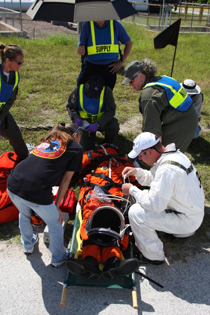 CAPE CANAVERAL, Fla. –  At NASA's Kennedy Space Center in Florida, a Mode II-IV exercise is underway at Launch Pad 39A, involving NASA fire rescue personnel, volunteers portraying astronauts with simulated injuries, helicopters and personnel from the Air Force’s 920th Rescue Wing and medical trauma teams at three central Florida hospitals.  The drill allows teams to practice an emergency response at Pad 39A, including helicopter evacuation to local hospitals. The Space Shuttle Program and U.S. Air Force are conducting the emergency simulation.  Photo credit: NASA/Dimitri Gerondidakis