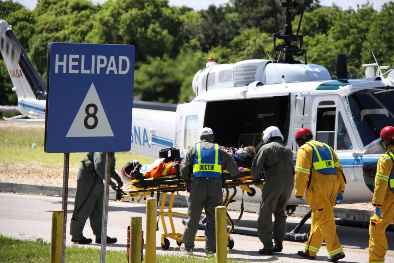 CAPE CANAVERAL, Fla. – At NASA's Kennedy Space Center in Florida, volunteers portraying astronauts are loaded into a helicopter as part of a Mode II-IV exercise that allows teams to practice an emergency response at Launch Pad 39A, including helicopter evacuation to local hospitals. The exercise involves NASA fire rescue personnel, volunteers portraying astronauts with simulated injuries, helicopters and personnel from the Air Force’s 920th Rescue Wing and medical trauma teams at three central Florida hospitals. The Space Shuttle Program and U.S. Air Force are conducting the emergency simulation. Photo credit:  NASA/Troy Cryder