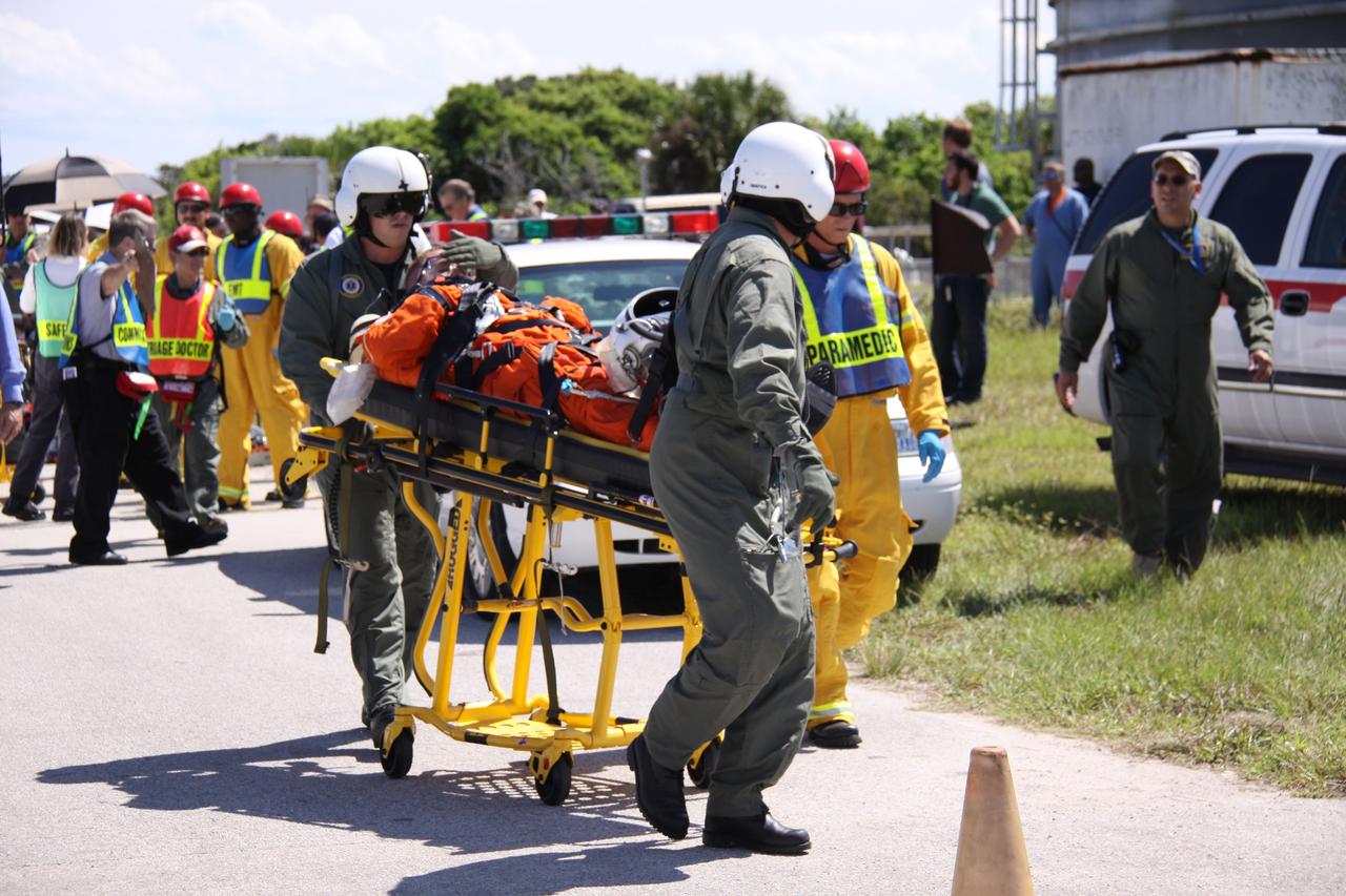 CAPE CANAVERAL, Fla. – At NASA's Kennedy Space Center in Florida, volunteers portraying astronauts are transported to helicopters as part of a Mode II-IV exercise that allows teams to practice an emergency response at Launch Pad 39A, including helicopter evacuation to local hospitals.  The exercise involves NASA fire rescue personnel, volunteers portraying astronauts with simulated injuries, helicopters and personnel from the Air Force’s 920th Rescue Wing and medical trauma teams at three central Florida hospitals. The Space Shuttle Program and U.S. Air Force are conducting the emergency simulation. Photo credit:  NASA/Troy Cryder