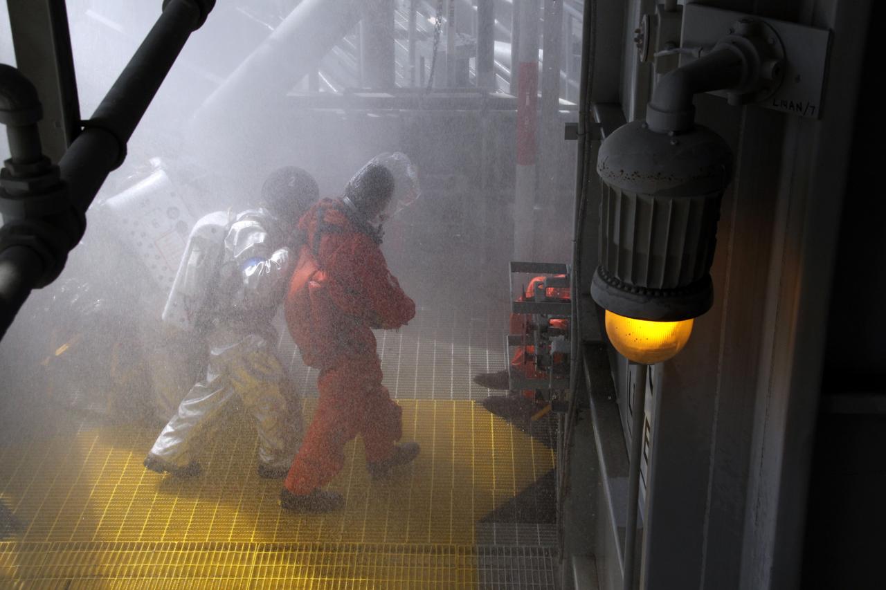 CAPE CANAVERAL, Fla. – At NASA  Kennedy Space Center's Launch Pad 39A, a Mode II-IV exercise is under way that allows teams to practice an emergency response, including helicopter evacuation to local hospitals. The exercise involves NASA fire rescue personnel, volunteers portraying astronauts with simulated injuries, helicopters and personnel from the Air Force’s 920th Rescue Wing and medical trauma teams at three central Florida hospitals. The Space Shuttle Program and U.S. Air Force are conducting the emergency simulation. Photo credit:  NASA/Jack Pfaller