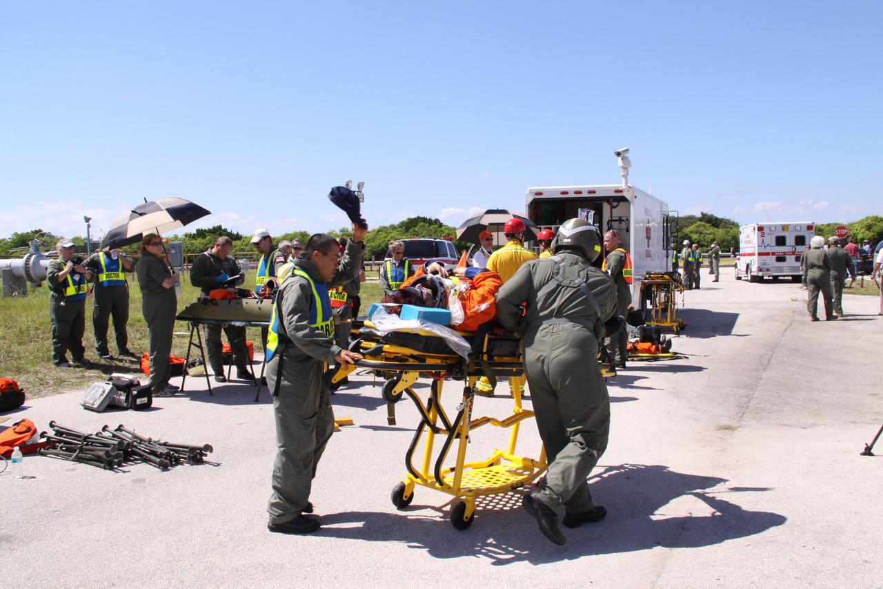 CAPE CANAVERAL, Fla. – At NASA's Kennedy Space Center in Florida, volunteers portraying astronauts are transported to and from a triage site as part of a Mode II-IV exercise that allows teams to practice an emergency response at Launch Pad 39A, including helicopter evacuation to local hospitals. The exercise involves NASA fire rescue personnel, volunteers portraying astronauts with simulated injuries, helicopters and personnel from the Air Force’s 920th Rescue Wing and medical trauma teams at three central Florida hospitals. The Space Shuttle Program and U.S. Air Force are conducting the emergency simulation. Photo credit:  NASA/Jack Pfaller