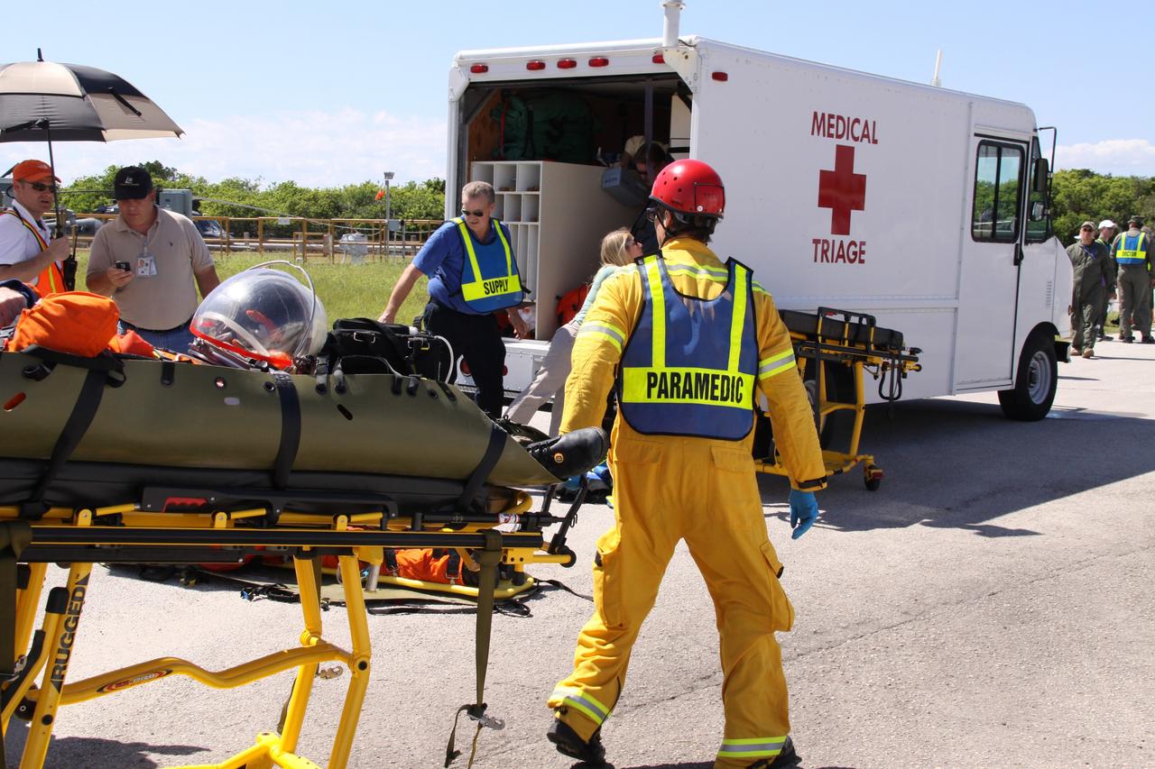 CAPE CANAVERAL, Fla. – At NASA's Kennedy Space Center in Florida, volunteers portraying astronauts are transported to ambulances  as part of a Mode II-IV exercise that allows teams to practice an emergency response at Launch Pad 39A, including helicopter evacuation to local hospitals.  The exercise involves NASA fire rescue personnel, volunteers portraying astronauts with simulated injuries, helicopters and personnel from the Air Force’s 920th Rescue Wing and medical trauma teams at three central Florida hospitals. The Space Shuttle Program and U.S. Air Force are conducting the emergency simulation. Photo credit:  NASA/Jack Pfaller