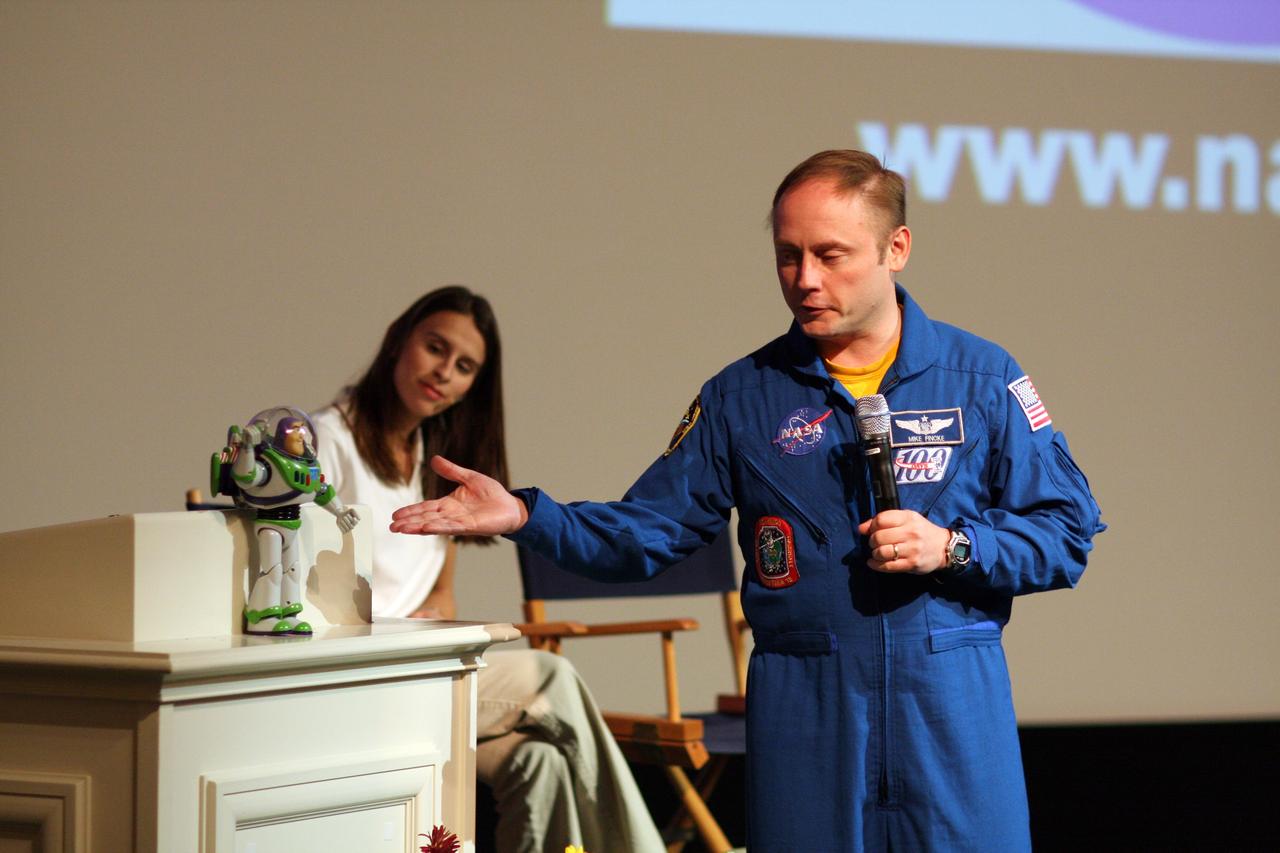 CAPE CANAVERAL, Fla. – At Walt Disney World's Magic Kingdom in Orlando, Fla., NASA astronaut Mike Fincke introduces toy space ranger Buzz Lightyear to students and teachers attending an education presentation, as Veronica Franco of NASA's Education Office at Kennedy Space Center looks on.  The event is part of the festivities to welcome Lightyear home from space.  Fincke was commander of the International Space Station from October 2008 to April 2009.    The 12-inch-tall action figure spent more than 15 months aboard the International Space Station and returned to Earth aboard space shuttle Discovery on Sept. 11 with the STS-128 crew.  Lightyear's space adventure, a collaboration between NASA and Disney Parks, is intended to share the excitement of space exploration with students around the world and encourage them to pursue studies in science, technology, engineering and mathematics.  For additional information, visit http://www.nasa.gov/buzzoniss.  Photo credit: NASA/Dimitri Gerondidakis