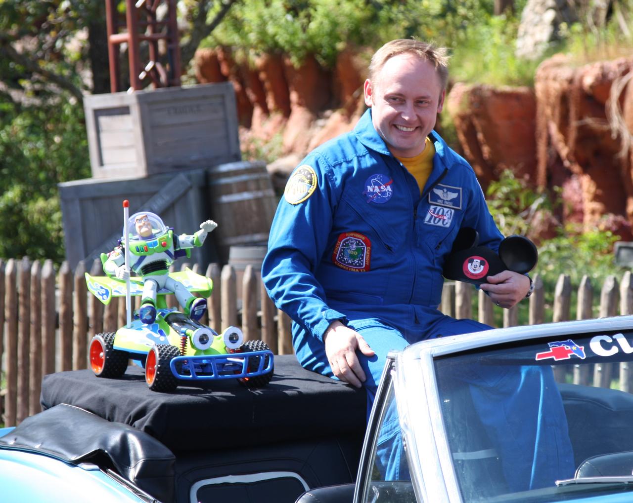 CAPE CANAVERAL, Fla. – At Walt Disney World's Magic Kingdom in Orlando, Fla., NASA astronaut Mike Fincke, riding in a 1968 Camaro convertible, participates in a ticker-tape parade, part of the festivities to welcome toy space ranger Buzz Lightyear, at his side, home from space.  Fincke was commander of the International Space Station from October 2008 to April 2009.    The 12-inch-tall action figure spent more than 15 months aboard the International Space Station and returned to Earth aboard space shuttle Discovery on Sept. 11 with the STS-128 crew.  Lightyear's space adventure, a collaboration between NASA and Disney Parks, is intended to share the excitement of space exploration with students around the world and encourage them to pursue studies in science, technology, engineering and mathematics.  For additional information, visit http://www.nasa.gov/buzzoniss.  Photo credit: NASA/Dimitri Gerondidakis