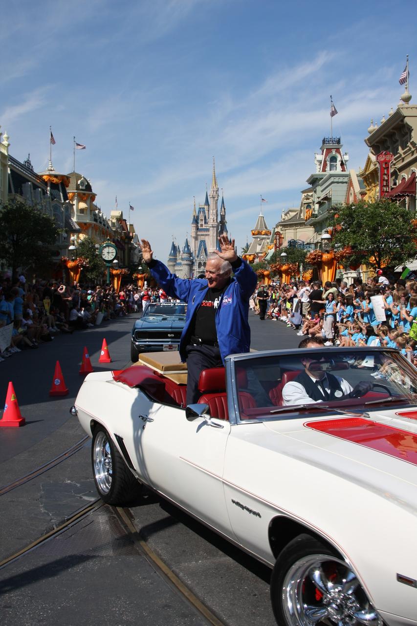 CAPE CANAVERAL, Fla. – At Walt Disney World's Magic Kingdom in Orlando, Fla., Apollo 11 astronaut Buzz Aldrin, riding in a 1969 Camaro convertible, participates in a ticker-tape parade to welcome his namesake, toy space ranger Buzz Lightyear, home from space.    The 12-inch-tall action figure spent more than 15 months aboard the International Space Station and returned to Earth aboard space shuttle Discovery on Sept. 11 with the STS-128 crew.  Lightyear's space adventure, a collaboration between NASA and Disney Parks, is intended to share the excitement of space exploration with students around the world and encourage them to pursue studies in science, technology, engineering and mathematics.  For additional information, visit http://www.nasa.gov/buzzoniss.  Photo credit: NASA/Dimitri Gerondidakis