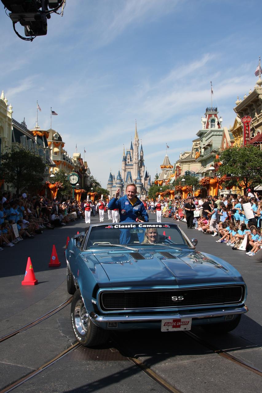 CAPE CANAVERAL, Fla. – At Walt Disney World's Magic Kingdom in Orlando, Fla., NASA astronaut Mike Fincke, riding in a 1968 Camaro convertible, participates in a ticker-tape parade, part of the festivities to welcome toy space ranger Buzz Lightyear home from space.  Fincke was commander of the International Space Station from October 2008 to April 2009.    The 12-inch-tall action figure spent more than 15 months aboard the International Space Station and returned to Earth aboard space shuttle Discovery on Sept. 11 with the STS-128 crew.  Lightyear's space adventure, a collaboration between NASA and Disney Parks, is intended to share the excitement of space exploration with students around the world and encourage them to pursue studies in science, technology, engineering and mathematics.  For additional information, visit http://www.nasa.gov/buzzoniss.  Photo credit: NASA/Dimitri Gerondidakis