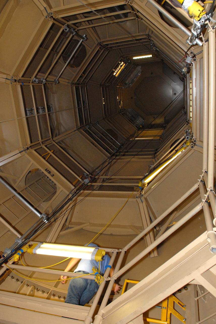 CAPE CANAVERAL, Fla. – In the Vehicle Assembly Building's High Bay 3 at Kennedy Space Center in Florida, a technician works on a platform mounted on the interior wall of the upper stage simulator of the 327-foot-tall Ares I-X rocket.    Part of the Constellation Program, the Ares I-X is the test vehicle for the Ares I, which is the essential core of a space transportation system designed to carry crewed missions back to the moon, on to Mars and out into the solar system. The Ares I-X flight test is targeted for Oct. 27. For information on the Ares I-X vehicle and flight test, visit http://www.nasa.gov/mission_pages/constellation/ares/flighttests/aresIx/index.html. Photo credit: NASA/Jim Grossmann