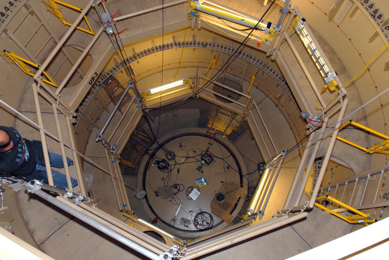 CAPE CANAVERAL, Fla. – In the Vehicle Assembly Building's High Bay 3 at Kennedy Space Center in Florida, a technician works on a platform mounted on the interior wall of the upper stage simulator of the 327-foot-tall Ares I-X rocket.    Part of the Constellation Program, the Ares I-X is the test vehicle for the Ares I, which is the essential core of a space transportation system designed to carry crewed missions back to the moon, on to Mars and out into the solar system. The Ares I-X flight test is targeted for Oct. 27. For information on the Ares I-X vehicle and flight test, visit http://www.nasa.gov/mission_pages/constellation/ares/flighttests/aresIx/index.html. Photo credit: NASA/Jim Grossmann