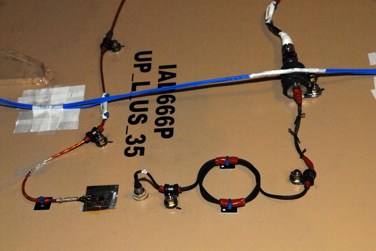 CAPE CANAVERAL, Fla. – In the Vehicle Assembly Building's High Bay 3 at Kennedy Space Center in Florida, Development Flight Instrumentation, or DFI, is mounted on the interior wall of the upper stage simulator of the 327-foot-tall Ares I-X rocket.  More than 700 sensors will gather data during the two-and-a-half minute flight test.    Part of the Constellation Program, the Ares I-X is the test vehicle for the Ares I, which is the essential core of a space transportation system designed to carry crewed missions back to the moon, on to Mars and out into the solar system. The Ares I-X flight test is targeted for Oct. 27. For information on the Ares I-X vehicle and flight test, visit http://www.nasa.gov/mission_pages/constellation/ares/flighttests/aresIx/index.html. Photo credit: NASA/Jim Grossmann