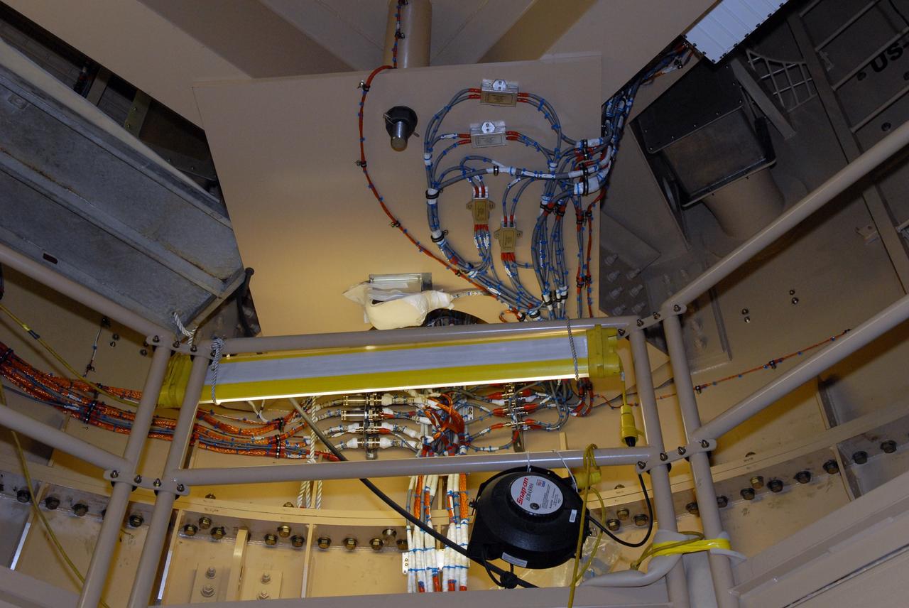 CAPE CANAVERAL, Fla. – In the Vehicle Assembly Building's High Bay 3 at Kennedy Space Center in Florida, Development Flight Instrumentation, or DFI, is mounted on the interior wall of the upper stage simulator of the 327-foot-tall Ares I-X rocket.  More than 700 sensors will gather data during the two-and-a-half minute flight test.    Part of the Constellation Program, the Ares I-X is the test vehicle for the Ares I, which is the essential core of a space transportation system designed to carry crewed missions back to the moon, on to Mars and out into the solar system. The Ares I-X flight test is targeted for Oct. 27. For information on the Ares I-X vehicle and flight test, visit http://www.nasa.gov/mission_pages/constellation/ares/flighttests/aresIx/index.html. Photo credit: NASA/Jim Grossmann