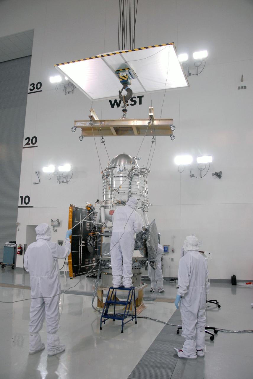 VANDENBERG AIR FORCE BASE, Calif. -- At the Astrotech processing facility on Vandenberg Air Force Base in California, workers prepare to lift NASA's Wide-field Infrared Survey Explorer, or WISE, for its move from the test stand for mating to its Payload Attach Fitting.    The satellite will survey the entire sky at infrared wavelengths, creating a cosmic clearinghouse of hundreds of millions of objects which will be catalogued and provide a vast storehouse of knowledge about the solar system, the Milky Way, and the universe. Launch is scheduled for Dec. 7.  Photo credit: NASA/Doug Kolkow
