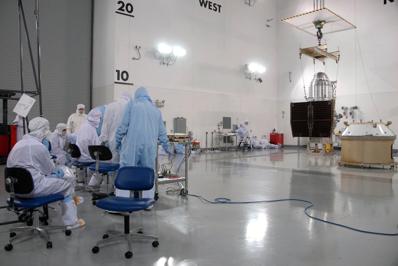 VANDENBERG AIR FORCE BASE, Calif. -- At the Astrotech processing facility on Vandenberg Air Force Base in California, workers prepare to lift NASA's Wide-field Infrared Survey Explorer, or WISE, by crane from its test stand for mating to its Payload Attach Fitting, at right.    The satellite will survey the entire sky at infrared wavelengths, creating a cosmic clearinghouse of hundreds of millions of objects which will be catalogued and provide a vast storehouse of knowledge about the solar system, the Milky Way, and the universe. Launch is scheduled for Dec. 7.  Photo credit: NASA/Doug Kolkow