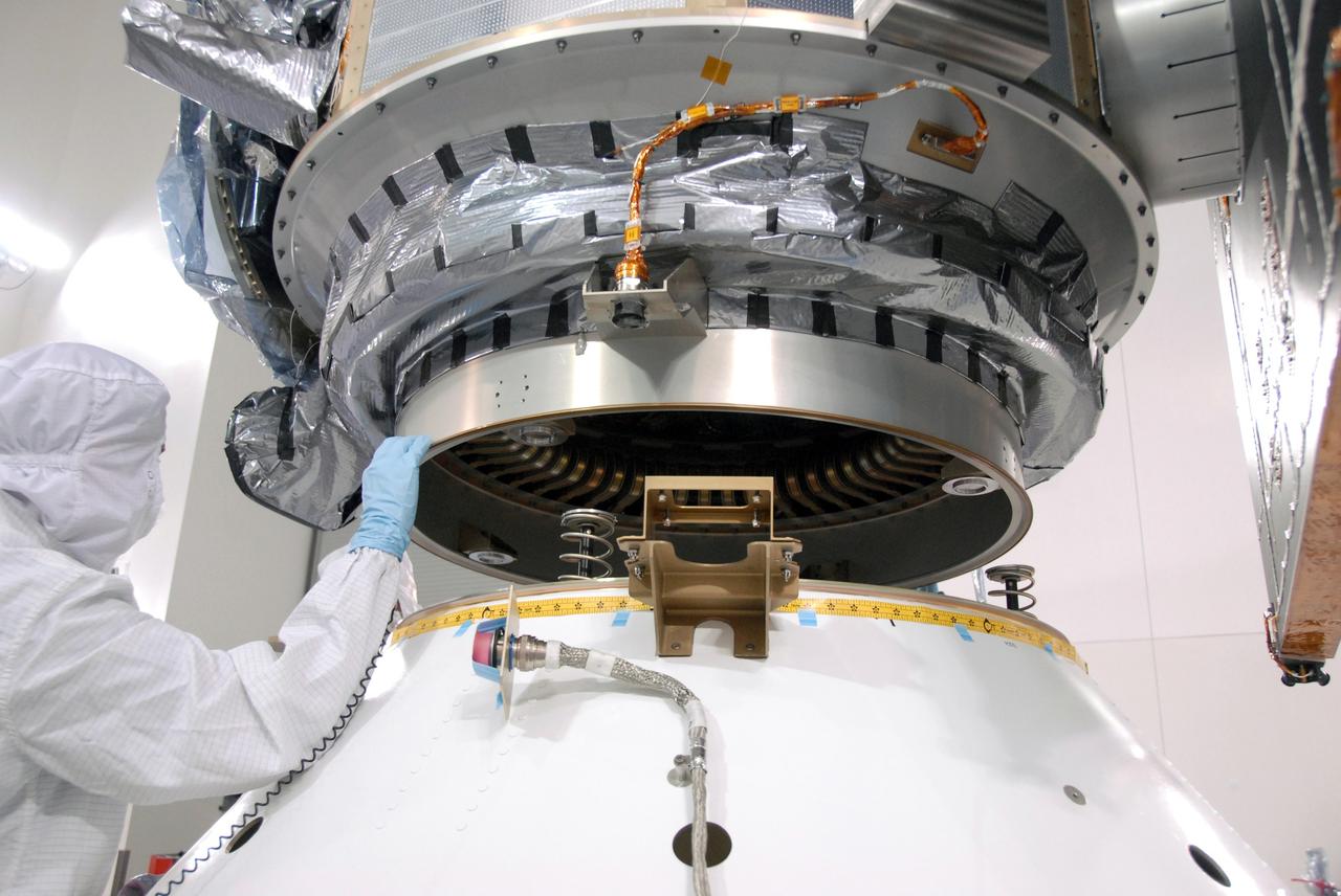 VANDENBERG AIR FORCE BASE, Calif. -- At the Astrotech processing facility on Vandenberg Air Force Base in California, workers guide NASA's Wide-field Infrared Survey Explorer, or WISE, into position for mating with its Payload Attach Fitting.    The satellite will survey the entire sky at infrared wavelengths, creating a cosmic clearinghouse of hundreds of millions of objects which will be catalogued and provide a vast storehouse of knowledge about the solar system, the Milky Way, and the universe. Launch is scheduled for Dec. 7.  Photo credit: NASA/Doug Kolkow