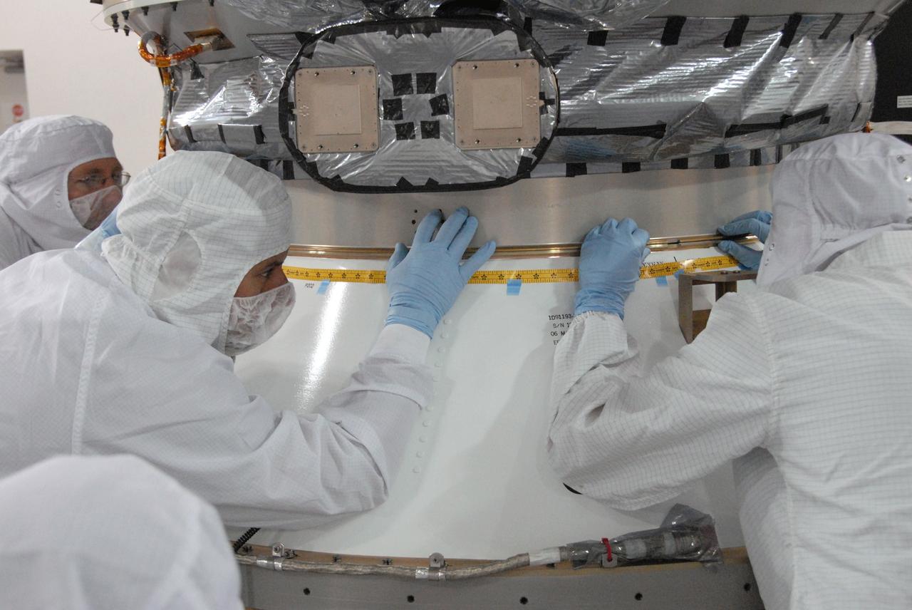 VANDENBERG AIR FORCE BASE, Calif. -- At the Astrotech processing facility on Vandenberg Air Force Base in California, workers mate NASA's Wide-field Infrared Survey Explorer, or WISE, to its Payload Attach Fitting.    The satellite will survey the entire sky at infrared wavelengths, creating a cosmic clearinghouse of hundreds of millions of objects which will be catalogued and provide a vast storehouse of knowledge about the solar system, the Milky Way, and the universe. Launch is scheduled for Dec. 7.  Photo credit: NASA/Doug Kolkow