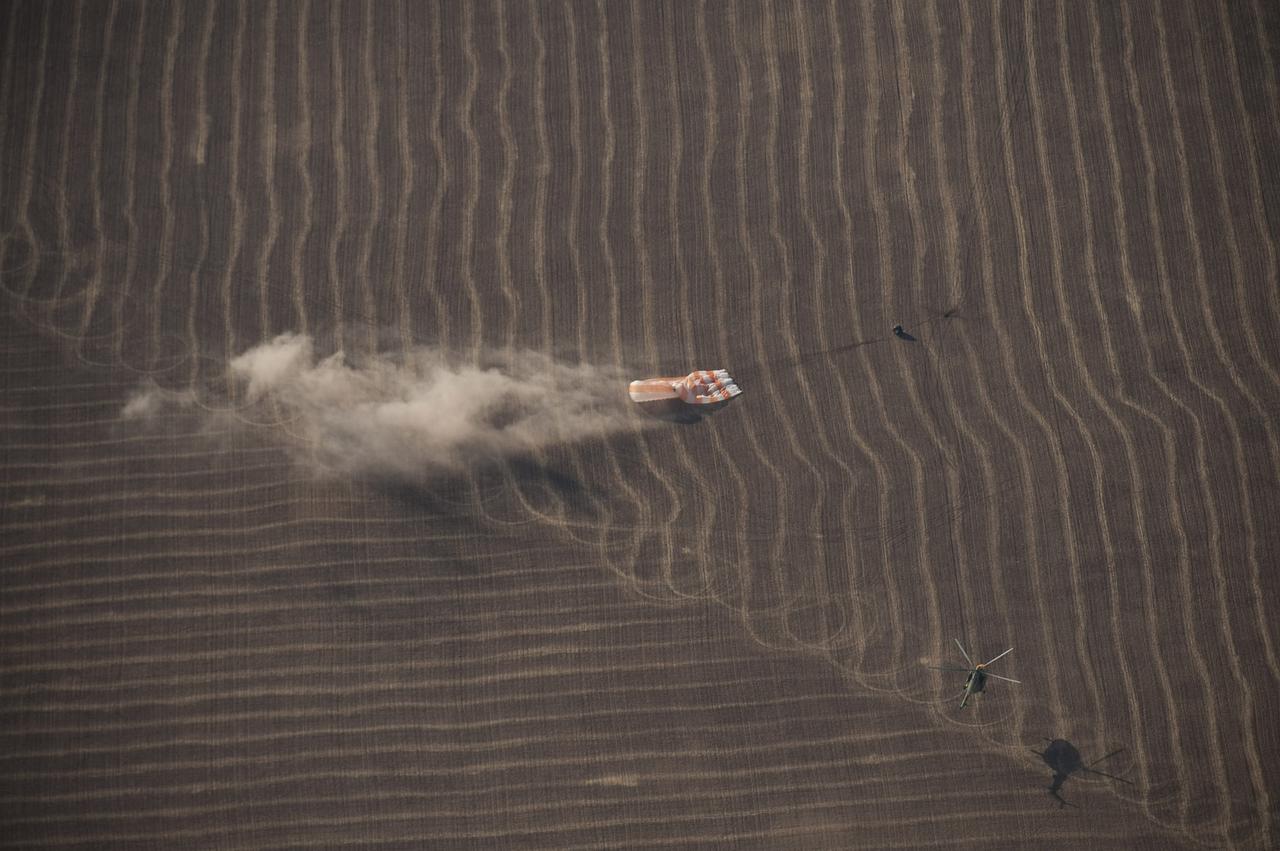 KAZAKHASTAN - The Soyuz TMA-14 spacecraft is seen as it lands with Expedition 20 Commander Gennady Padalka, Flight Engineer Michael Barratt, and spaceflight participant Guy Laliberte near the town of Arkalyk, Kazakhstan, on Sunday, Oct. 11, 2009. Padalka and Barratt are returning from six months onboard the International Space Station, along with Laliberte who arrived at the station on Oct. 2 with Expedition 21 Flight Engineers Jeff Williams and Maxim Suraev aboard the Soyuz TMA-16 spacecraft. Photo Credit: NASA/Bill Ingalls