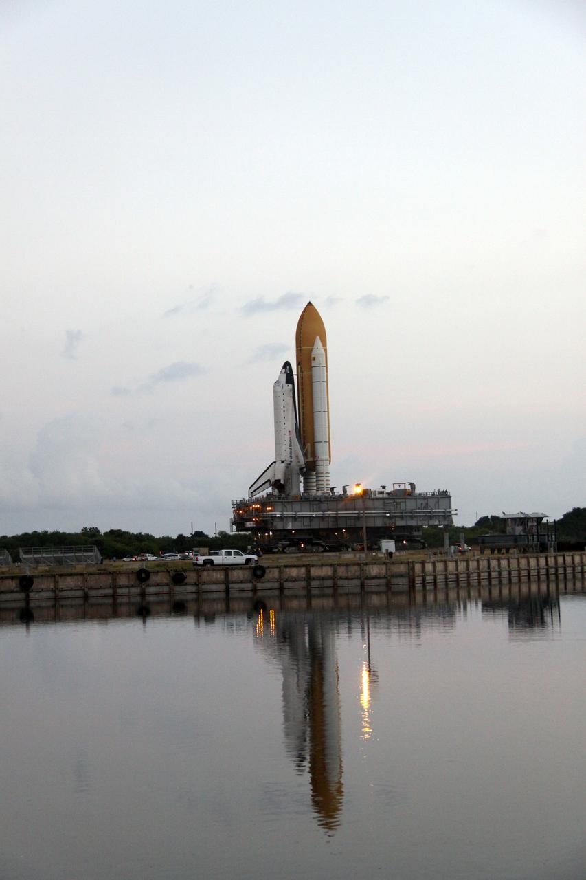 CAPE CANAVERAL, Fla. – At NASA's Kennedy Space Center in Florida, space shuttle Atlantis is reflected in the still water of the turn basin as it makes its 3.4-mile trip, known as rollout, from the Vehicle Assembly Building to Launch Pad 39A. First motion was at 6:38 a.m. EDT Oct. 14. Rollout is expected to take about six hours.    Liftoff of Atlantis on its STS-129 mission to the International Space Station is targeted for Nov. 12. For information on the STS-129 mission and crew, visit http://www.nasa.gov/mission_pages/shuttle/shuttlemissions/sts129/index.html. Photo credit: NASA/Jack Pfaller