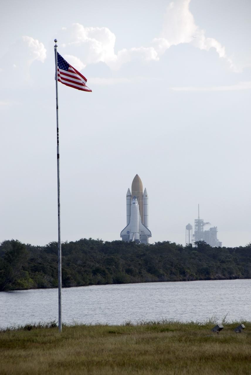 CAPE CANAVERAL, Fla. – At NASA's Kennedy Space Center in Florida, space shuttle Atlantis appears to float above the trees on its 3.4-mile trip from the Vehicle Assembly Building to Launch Pad 39A, in the background at right. In reality, the shuttle is secured to its mobile launcher platform for the move, known as rollout, and is being carried by a crawler-transporter. First motion was at 6:38 a.m. EDT Oct. 14. Rollout is expected to take about six hours. Liftoff of Atlantis on its STS-129 mission to the International Space Station is targeted for Nov. 12. For information on the STS-129 mission and crew, visit http://www.nasa.gov/mission_pages/shuttle/shuttlemissions/sts129/index.html. Photo credit: NASA/Kim Shiflett