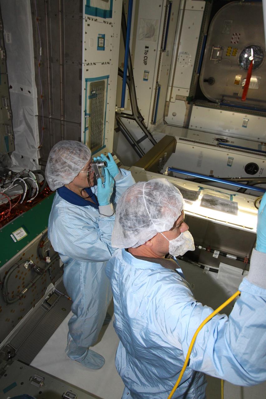 CAPE CANAVERAL, Fla. – Mission specialist Kathryn "Kay" Hire, at left, assigned to the crew of space shuttle Endeavour's STS-130 mission, takes a tour of the Tranquility Node 3 module in the Space Station Processing Facility at NASA's Kennedy Space Center in Florida. Assisting her, at right, is Chris Hardcastle, an STS-130 flight crew representative with United Space Alliance.    Tranquility is a pressurized module that will provide room for many of the International Space Station's life support systems. Attached to the node is a cupola, a unique work station with six windows on its sides and one on top. Tranquility is the payload for the STS-130 mission. The module was built for the European Space Agency by Alenia Spazio in Turin, Italy. Cupola resembles a circular bay window that will provide a vastly improved view of the station's exterior. Just under 10 feet in diameter, the module will accommodate two crew members and portable workstations that can control station and robotic activities. The multi-directional view will allow the crew to monitor spacewalks and docking operations, as well as provide a spectacular view of Earth and other celestial objects. Endeavour is targeted to launch Feb. 4, 2010. Photo credit: NASA/Jack Pfaller