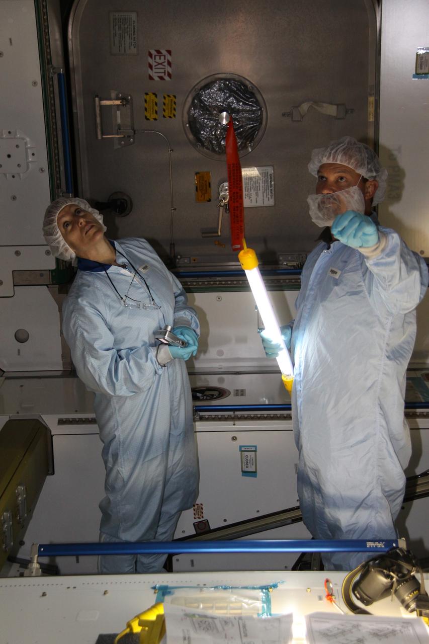 CAPE CANAVERAL, Fla. – Mission specialist Kathryn "Kay" Hire, at left, a crew member on space shuttle Endeavour's STS-130 mission, participates in familiarization training for the Tranquility Node 3 module in the Space Station Processing Facility at NASA's Kennedy Space Center in Florida. Assisting her, at right, is Chris Hardcastle, an STS-130 flight crew representative with United Space Alliance.    Tranquility is a pressurized module that will provide room for many of the International Space Station's life support systems. Attached to the node is a cupola, a unique work station with six windows on its sides and one on top. Tranquility is the payload for the STS-130 mission. The module was built for the European Space Agency by Alenia Spazio in Turin, Italy. Cupola resembles a circular bay window that will provide a vastly improved view of the station's exterior. Just under 10 feet in diameter, the module will accommodate two crew members and portable workstations that can control station and robotic activities. The multi-directional view will allow the crew to monitor spacewalks and docking operations, as well as provide a spectacular view of Earth and other celestial objects. Endeavour is targeted to launch Feb. 4, 2010. Photo credit: NASA/Jack Pfaller