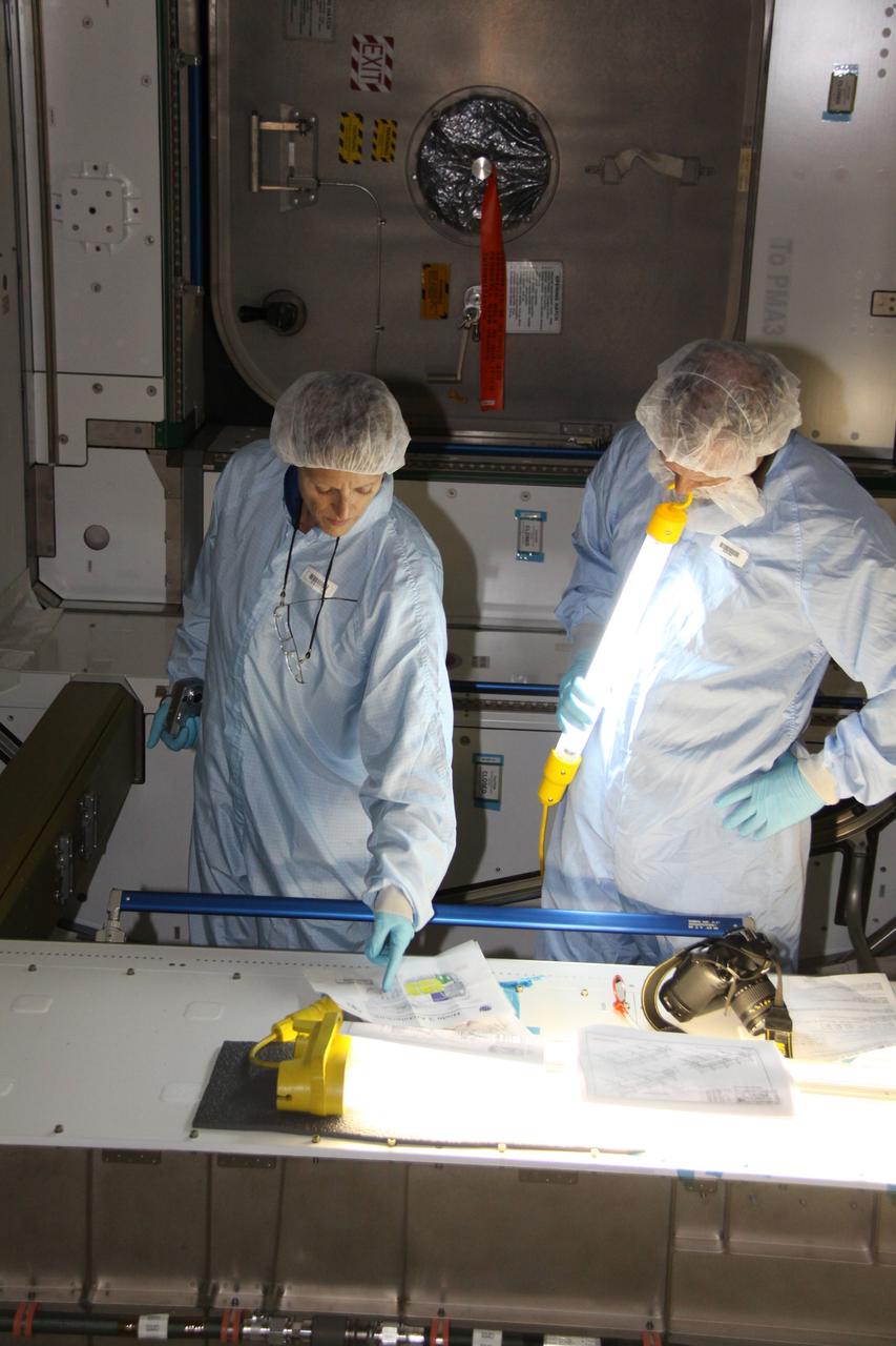 CAPE CANAVERAL, Fla. – In the Space Station Processing Facility at NASA's Kennedy Space Center in Florida, mission specialist Kathryn "Kay" Hire, left, a crew member on space shuttle Endeavour's STS-130 mission, discusses the layout of the Tranquility Node 3 module in which she is standing with Chris Hardcastle, an STS-130 flight crew representative with United Space Alliance.    Tranquility is a pressurized module that will provide room for many of the International Space Station's life support systems. Attached to the node is a cupola, a unique work station with six windows on its sides and one on top. Tranquility is the payload for the STS-130 mission. The module was built for the European Space Agency by Alenia Spazio in Turin, Italy. Cupola resembles a circular bay window that will provide a vastly improved view of the station's exterior. Just under 10 feet in diameter, the module will accommodate two crew members and portable workstations that can control station and robotic activities. The multi-directional view will allow the crew to monitor spacewalks and docking operations, as well as provide a spectacular view of Earth and other celestial objects. Endeavour is targeted to launch Feb. 4, 2010. Photo credit: NASA/Jack Pfaller