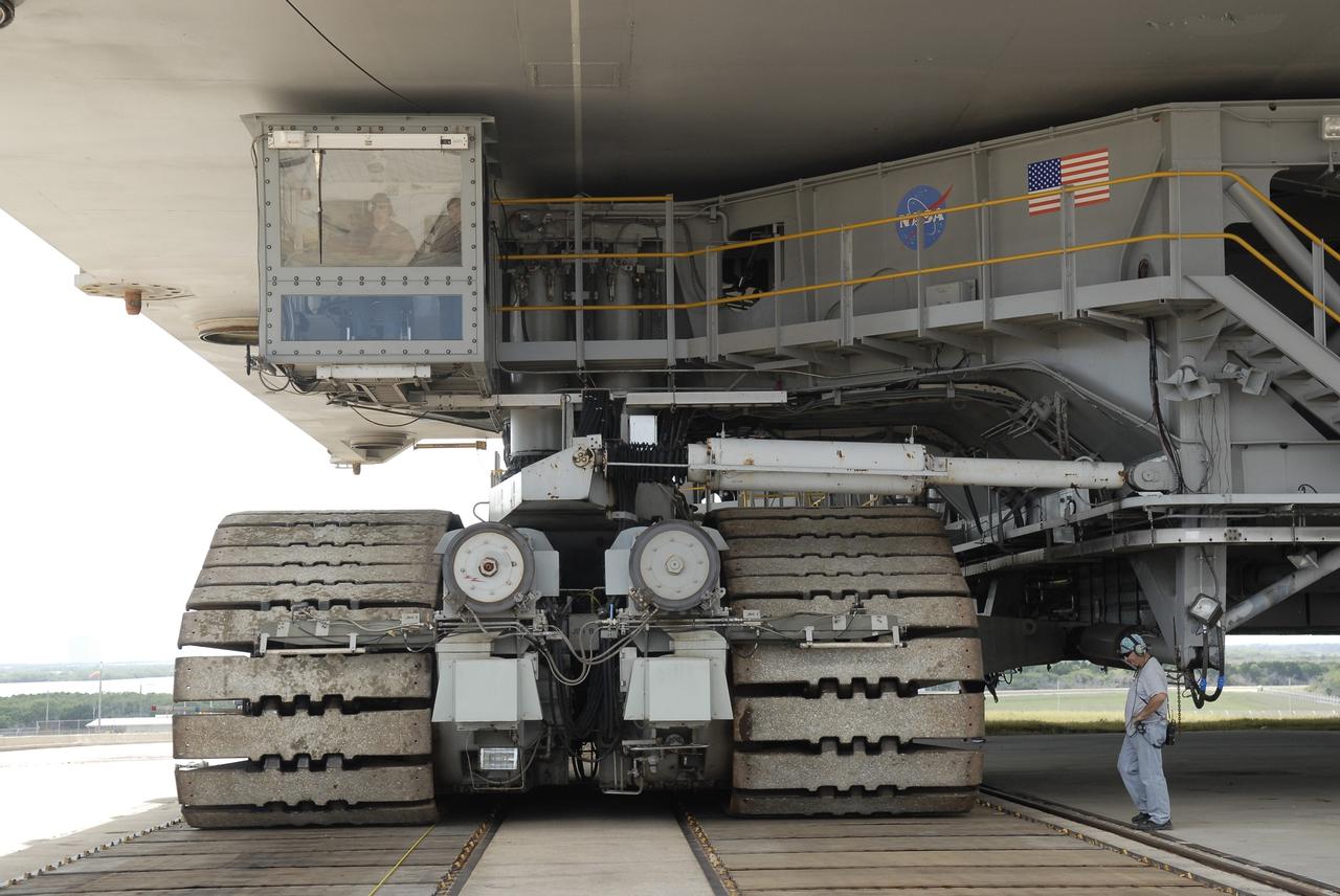 CAPE CANAVERAL, Fla. – At NASA's Kennedy Space Center in Florida, workers carefully guide the crawler-transporter into position on Launch Pad 39A.  Space shuttle Atlantis, not in view, towers above them as it nears the end of its 3.4-mile journey from the Vehicle Assembly Building, known as rollout.  First motion was at 6:38 a.m. EDT Oct. 14. The rollout took about six hours, and the shuttle was secure on the pad at 1:31 p.m.     Liftoff of Atlantis on its STS-129 mission to the International Space Station is targeted for Nov. 12. For information on the STS-129 mission and crew, visit http://www.nasa.gov/mission_pages/shuttle/shuttlemissions/sts129/index.html. Photo credit: NASA/Kim Shiflett