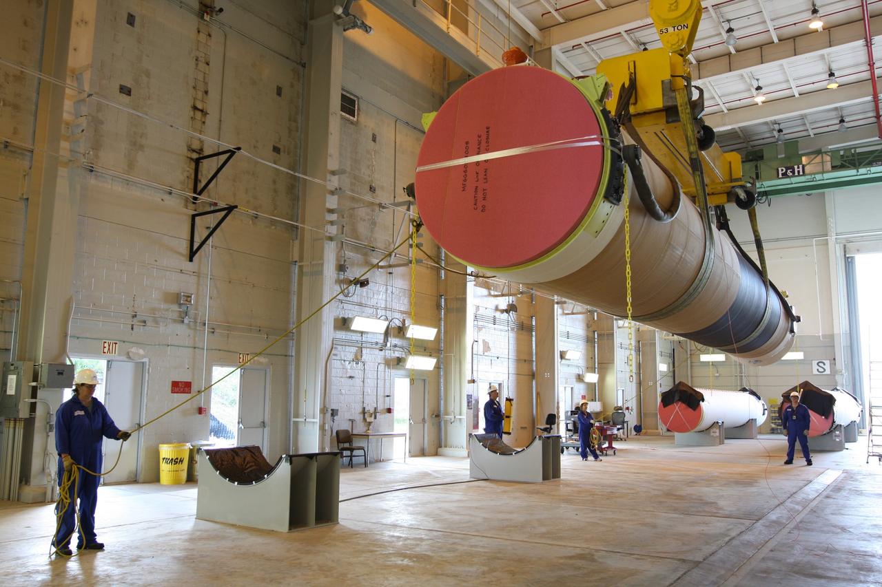 CAPE CANAVERAL, Fla. – At the Receipt Inspection Shop on Cape Canaveral Air Force Station in Florida, ATK Space Systems workers guide a 60-inch graphite epoxy motor, or GEM, slated for launch of the GOES-P spacecraft as it is lowered toward a work stand. The United Launch Alliance Delta IV is the launch vehicle for GOES-P, the latest Geostationary Operational Environmental Satellite developed by NASA for the National Oceanic and Atmospheric Administration, or NOAA. Launch is targeted for March 4, 2010, from Launch Complex 37. For information on GOES-P, visit http://nasascience.nasa.gov/missions/goes-n-o-p. Photo credit: NASA/Dimitri Gerondidakis