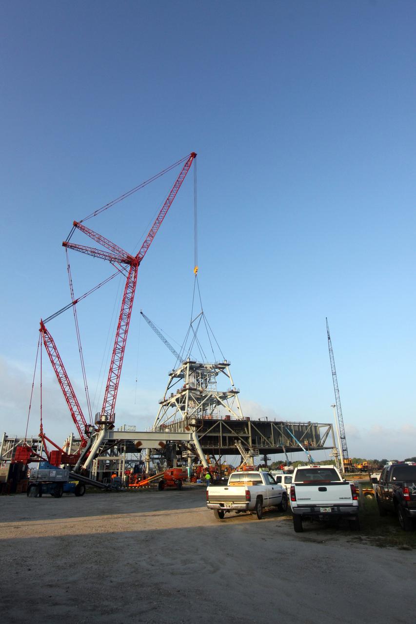 CAPE CANAVERAL, Fla. – At NASA's Kennedy Space Center in Florida, progress continues on the construction of a new mobile launcher, or ML, for the Constellation Program as a crane lifts the second section of the launcher's tower into place. Installation of the first section was on Sept. 24. The tower will have multiple platforms for personnel access and be approximately 345 feet tall. The launcher is being built at the mobile launcher park site area located north of Kennedy's Vehicle Assembly Building to support the Ares I rocket. The ML will provide a base to launch the Ares I which will transport the Orion crew exploration vehicle, its crew and cargo to low Earth orbit. The base is being made lighter than space shuttle mobile launcher platforms so the crawler-transporter can pick up the heavier load of the tower and taller rocket. For information on the Ares I, visit http://www.nasa.gov/ares. Photo credit: NASA/Jack Pfaller