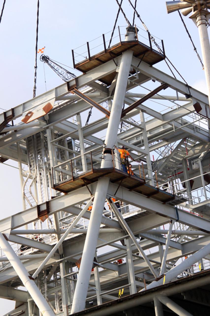 CAPE CANAVERAL, Fla. – At NASA's Kennedy Space Center in Florida, workers secure the second section of a tower for a new mobile launcher, or ML, for the Constellation Program to the first. Installation of the first section was on Sept. 24. The tower will have multiple platforms for personnel access and be approximately 345 feet tall. The launcher is being built at the mobile launcher park site area located north of Kennedy's Vehicle Assembly Building to support the Ares I rocket. The ML will provide a base to launch the Ares I which will transport the Orion crew exploration vehicle, its crew and cargo to low Earth orbit. The base is being made lighter than space shuttle mobile launcher platforms so the crawler-transporter can pick up the heavier load of the tower and taller rocket. For information on the Ares I, visit http://www.nasa.gov/ares. Photo credit: NASA/Jack Pfaller