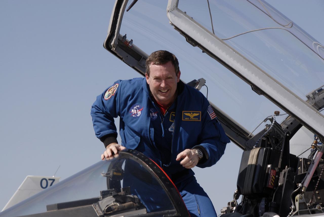 CAPE CANAVERAL, Fla. - STS-129 Mission Specialist Mike Foreman is all smiles as he disembarks from a T-38 at the Shuttle Landing Facility at NASA's Kennedy Space Center in Florida. The crew members of space shuttle Atlantis' STS-129 mission have arrived at Kennedy for training related to their launch dress rehearsal, the Terminal Countdown Demonstration Test. Launch of Atlantis on its STS-129 mission to the International Space Station is targeted for November. For information on the STS-129 mission objectives and crew, visit http://www.nasa.gov/mission_pages/shuttle/shuttlemissions/sts129/index.html. Photo credit: NASA/Kim Shiflett