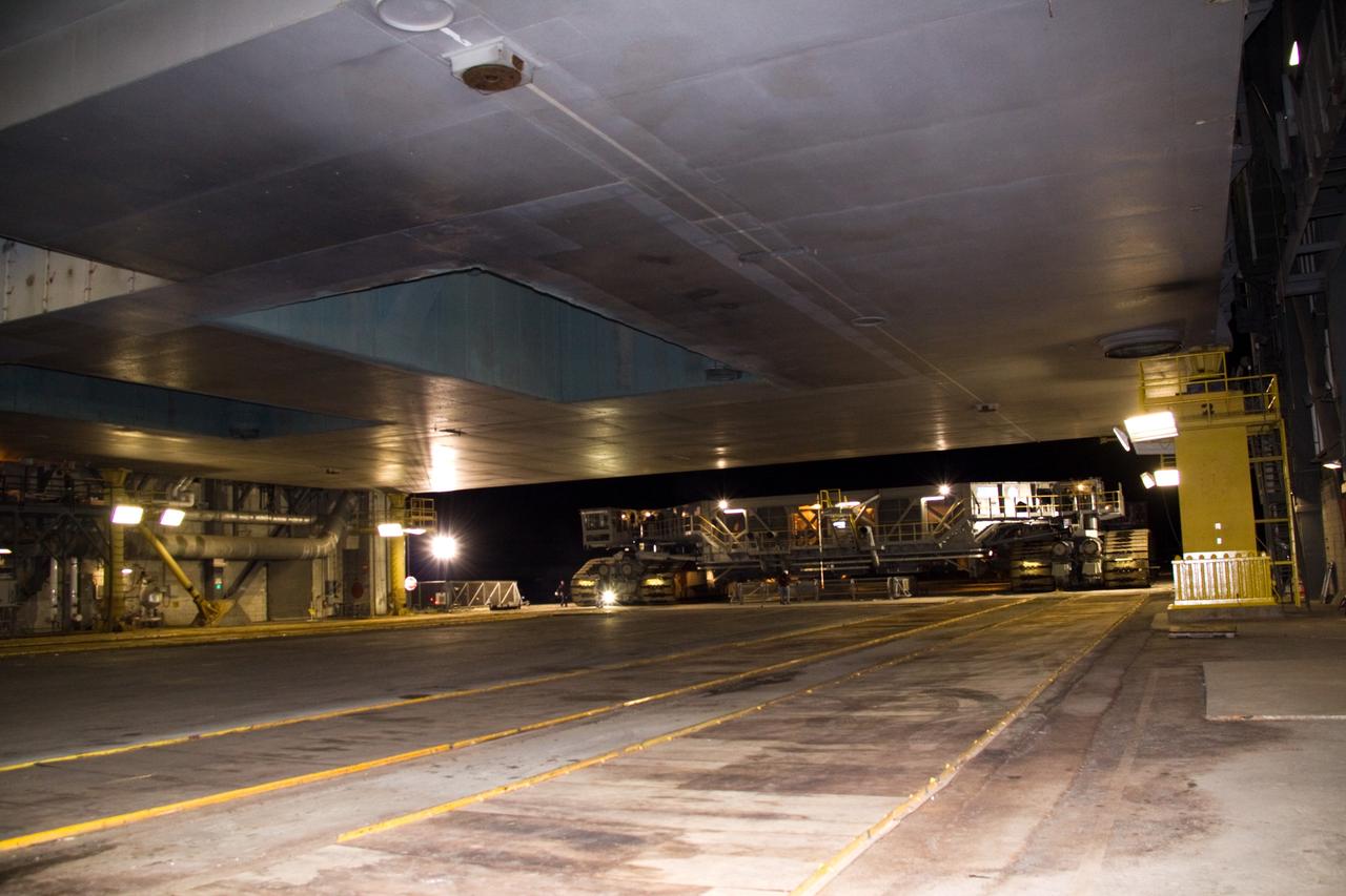CAPE CANAVERAL, Fla. – Inside the Vehicle Assembly Building at NASA's Kennedy Space Center in Florida, a crawler-transporter prepares to move under the mobile launcher platform holding the 327-foot-tall Ares I-X rocket. The crawler-transporter will carry the rocket on the 4.2-mile journey to Launch Pad 39B.    The transfer of the pad from the Space Shuttle Program to the Constellation Program took place May 31. Modifications made to the pad include the removal of shuttle unique subsystems, such as the orbiter access arm and a section of the gaseous oxygen vent arm, along with the installation of three 600-foot lightning towers, access platforms, environmental control systems and a vehicle stabilization system.  Part of the Constellation Program, the Ares I-X is the test vehicle for the Ares I. The Ares I-X flight test is targeted for Oct. 27. For information on the Ares I-X vehicle and flight test, visit http://www.nasa.gov/aresIX. Photo credit: NASA/Jack Pfaller