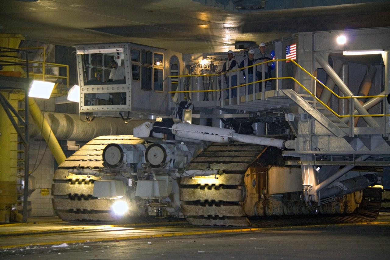 CAPE CANAVERAL, Fla. – Inside the Vehicle Assembly Building at NASA's Kennedy Space Center in Florida, the driver of the crawler-transporter (upper left) slowly maneuvers the huge vehicle under the mobile launcher platform holding the 327-foot-tall Ares I-X rocket. The crawler-transporter will carry the rocket on the 4.2-mile journey to Launch Pad 39B.     The transfer of the pad from the Space Shuttle Program to the Constellation Program took place May 31. Modifications made to the pad include the removal of shuttle unique subsystems, such as the orbiter access arm and a section of the gaseous oxygen vent arm, along with the installation of three 600-foot lightning towers, access platforms, environmental control systems and a vehicle stabilization system.  Part of the Constellation Program, the Ares I-X is the test vehicle for the Ares I. The Ares I-X flight test is targeted for Oct. 27. For information on the Ares I-X vehicle and flight test, visit http://www.nasa.gov/aresIX. Photo credit: NASA/Jack Pfaller
