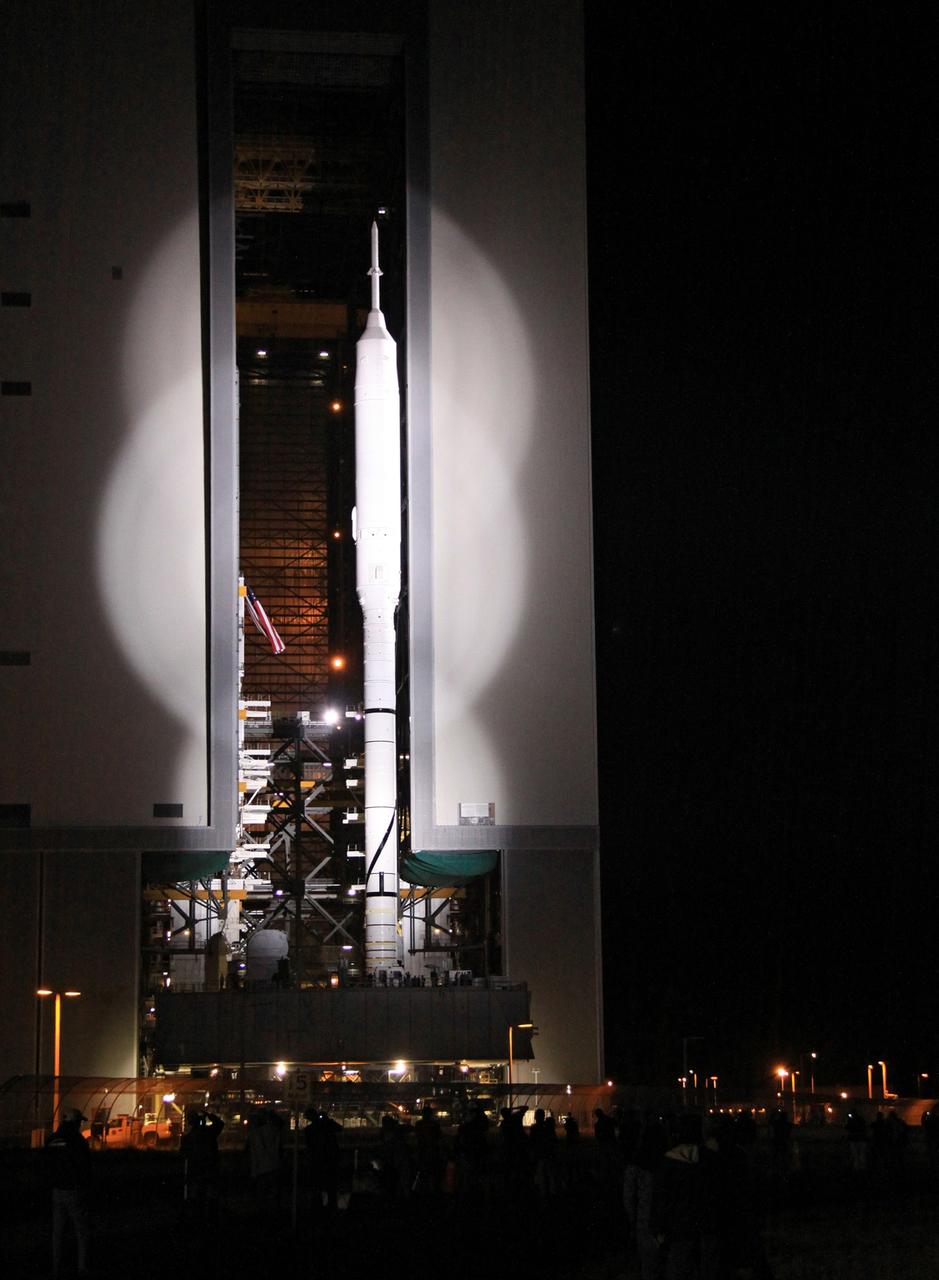 CAPE CANAVERAL, Fla. – Spotlighted in brilliant white, the 327-foot-tall Ares I-X rocket emerges from the Vehicle Assembly Building at NASA's Kennedy Space Center in Florida. The move to the launch pad, known as "rollout," began at 1:39 a.m. EDT. The transfer of the pad from the Space Shuttle Program to the Constellation Program took place May 31. Modifications made to the pad include the removal of shuttle unique subsystems, such as the orbiter access arm and a section of the gaseous oxygen vent arm, along with the installation of three 600-foot lightning towers, access platforms, environmental control systems and a vehicle stabilization system. Part of the Constellation Program, the Ares I-X is the test vehicle for the Ares I. The Ares I-X flight test is targeted for Oct. 27. For information on the Ares I-X vehicle and flight test, visit http://www.nasa.gov/aresIX. Photo credit: NASA/Jack Pfaller