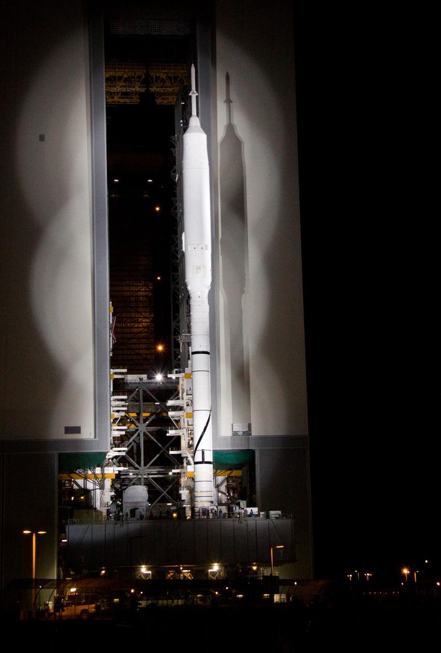 CAPE CANAVERAL, Fla. – The 327-foot-tall Ares I-X rocket clears the door of the Vehicle Assembly Building at NASA's Kennedy Space Center in Florida, on its way to Launch Pad 39B. The move to the launch pad, known as "rollout," began at 1:39 a.m. EDT. The transfer of the pad from the Space Shuttle Program to the Constellation Program took place May 31. Modifications made to the pad include the removal of shuttle unique subsystems, such as the orbiter access arm and a section of the gaseous oxygen vent arm, along with the installation of three 600-foot lightning towers, access platforms, environmental control systems and a vehicle stabilization system. Part of the Constellation Program, the Ares I-X is the test vehicle for the Ares I. The Ares I-X flight test is targeted for Oct. 27. For information on the Ares I-X vehicle and flight test, visit http://www.nasa.gov/aresIX. Photo credit: NASA/Jack Pfaller