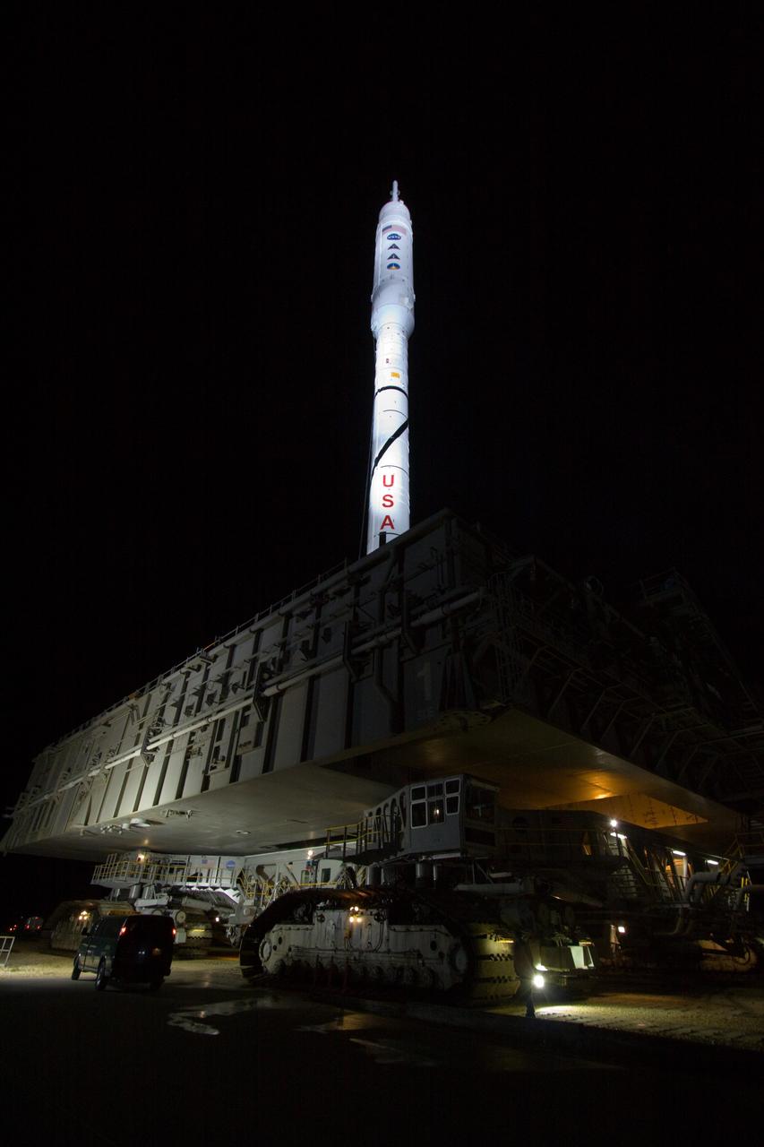 CAPE CANAVERAL, Fla. - The towering 327-foot-tall Ares I-X rocket, brightly lit against the night sky, rides aboard a crawler-transporter for the 4.2-mile trip to Launch Pad 39B at NASA's Kennedy Space Center in Florida. The rocket is bolted to its mobile launcher platform. The move to the launch pad, known as "rollout," began at 1:39 a.m. EDT.    The transfer of the pad from the Space Shuttle Program to the Constellation Program took place May 31. Modifications made to the pad include the removal of shuttle unique subsystems, such as the orbiter access arm and a section of the gaseous oxygen vent arm, along with the installation of three 600-foot lightning towers, access platforms, environmental control systems and a vehicle stabilization system.  Part of the Constellation Program, the Ares I-X is the test vehicle for the Ares I. The Ares I-X flight test is targeted for Oct. 27. For information on the Ares I-X vehicle and flight test, visit http://www.nasa.gov/aresIX. Photo credit: NASA/Jack Pfaller