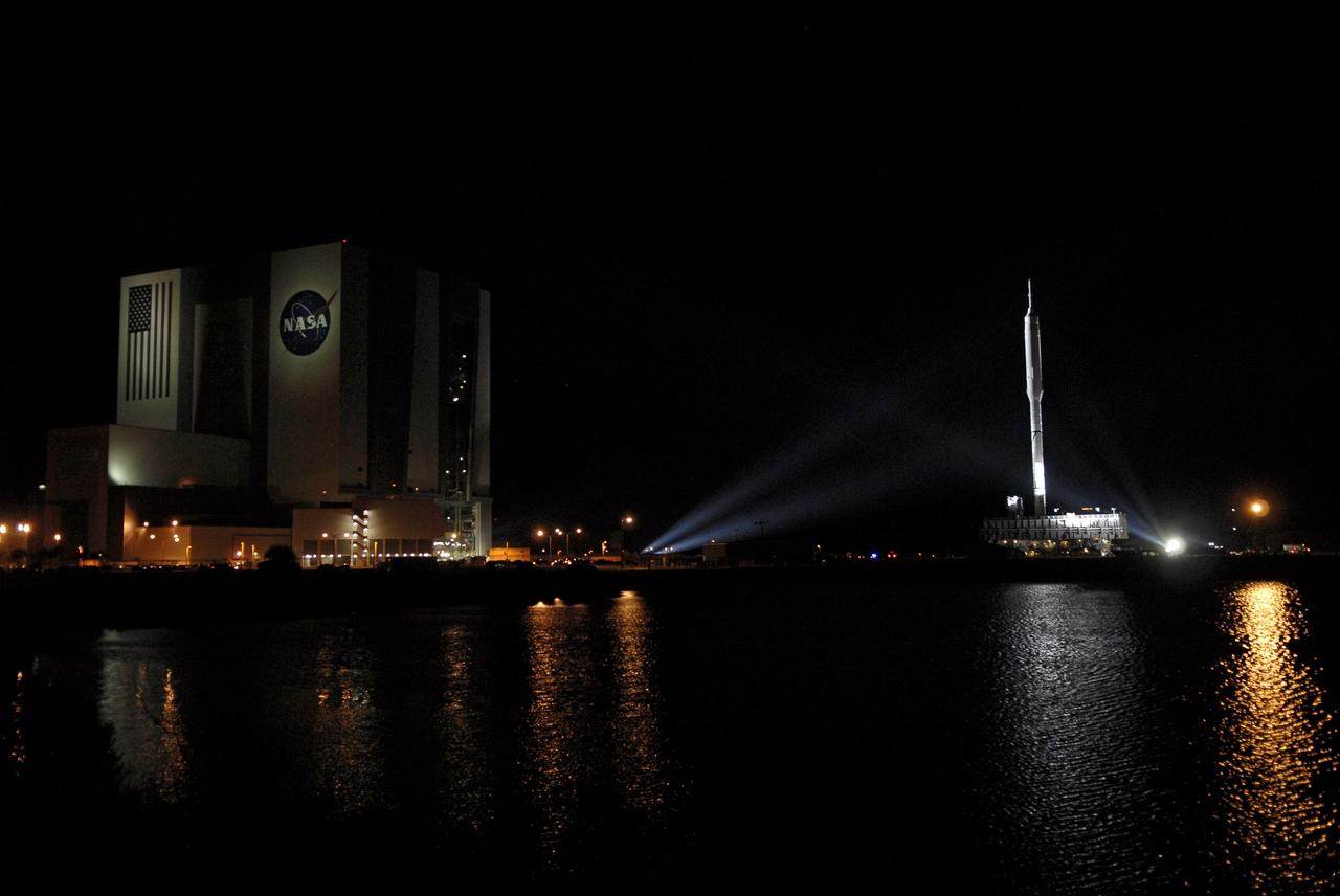 CAPE CANAVERAL, Fla. - The towering 327-foot-tall Ares I-X rocket moves away from the Vehicle Assembly Building at NASA's Kennedy Space Center in Florida. The rocket's slow, 4.2-mile journey to Launch Pad 39B began at 1:39 a.m. EDT.    The transfer of the pad from the Space Shuttle Program to the Constellation Program took place May 31. Modifications made to the pad include the removal of shuttle unique subsystems, such as the orbiter access arm and a section of the gaseous oxygen vent arm, along with the installation of three 600-foot lightning towers, access platforms, environmental control systems and a vehicle stabilization system.  Part of the Constellation Program, the Ares I-X is the test vehicle for the Ares I. The Ares I-X flight test is targeted for Oct. 27. For information on the Ares I-X vehicle and flight test, visit http://www.nasa.gov/aresIX. Photo credit: NASA/Kim Shiflett