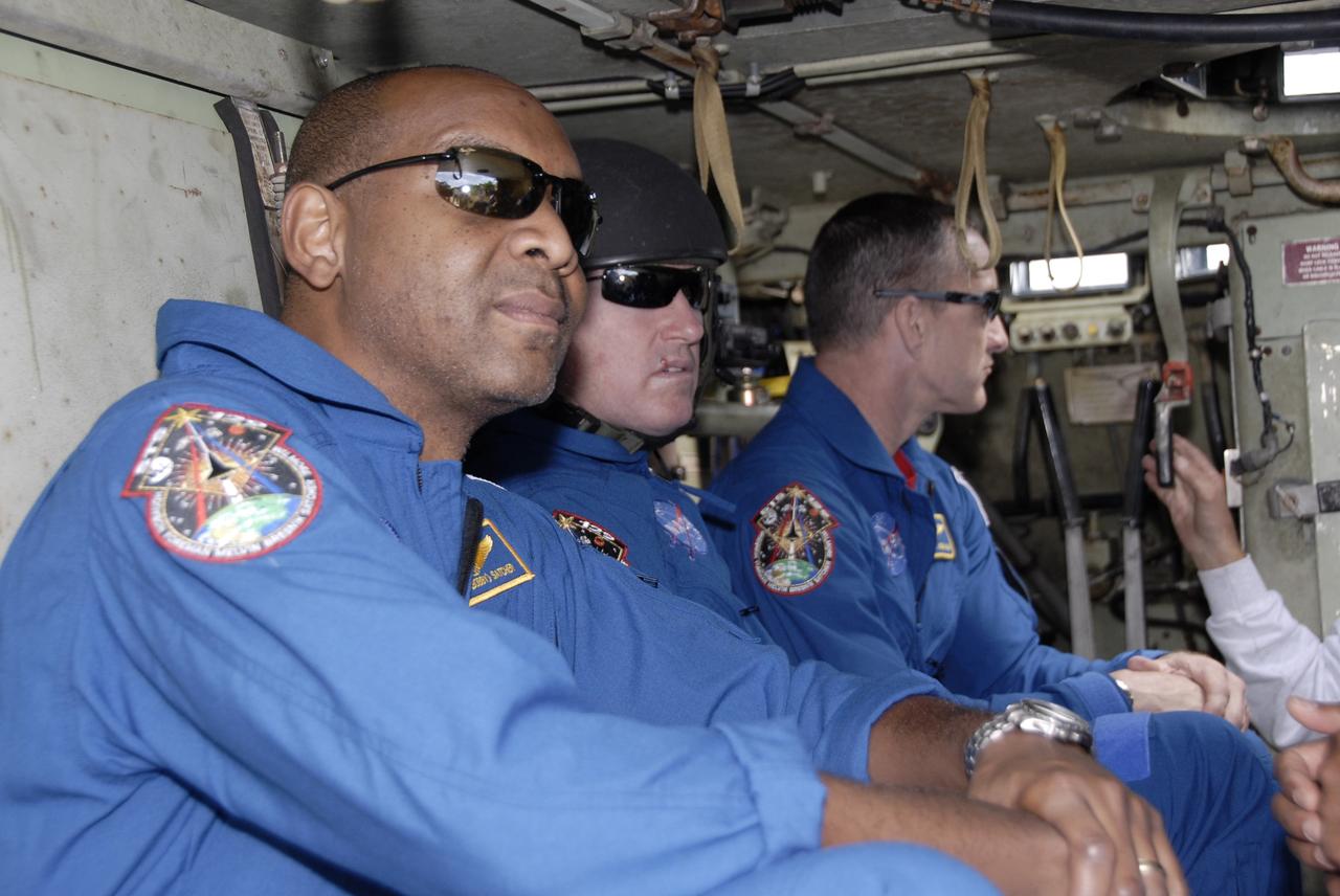 CAPE CANAVERAL, Fla. - At NASA's Kennedy Space Center in Florida, members of the STS-129 crew receive instruction on the operation of an M113 inside the armored personnel carrier. From left are Mission Specialist Robert L. Satcher Jr., Pilot Barry E. Wilmore and Commander Charles O. Hobaugh.    The M113 is kept at the foot of the launch pad in case an emergency egress from the vicinity of the pad is needed.  The crew members of space shuttle Atlantis' STS-129 mission are at Kennedy for training related to their launch dress rehearsal, the Terminal Countdown Demonstration Test.  Launch of Atlantis on its STS-129 mission to the International Space Station is targeted for Nov. 16. For information on the STS-129 mission objectives and crew, visit http://www.nasa.gov/mission_pages/shuttle/shuttlemissions/sts129/index.html. Photo credit: NASA/Kim Shiflett
