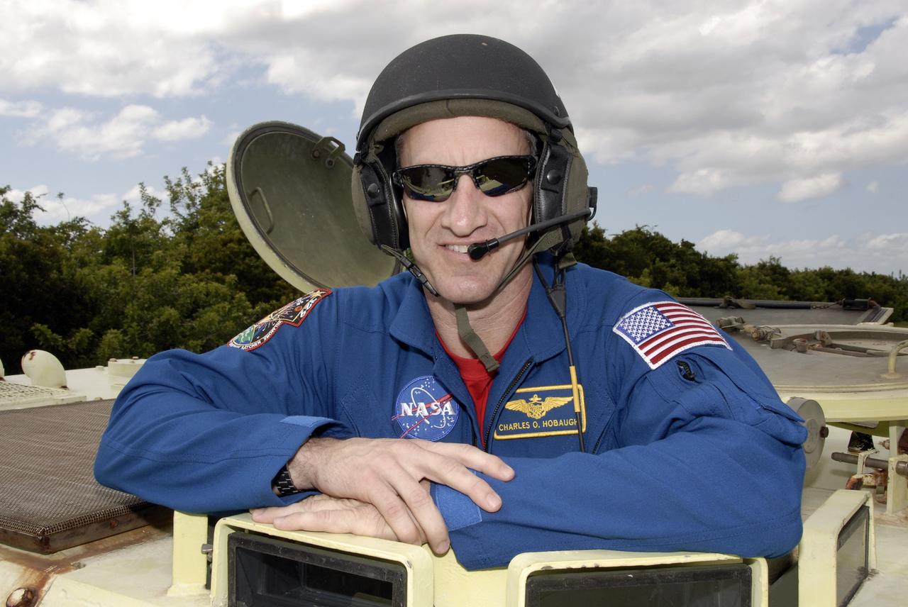 CAPE CANAVERAL, Fla. - At NASA's Kennedy Space Center in Florida, STS-129 Commander Charles O. Hobaugh prepares to drive an M113 armored personnel carrier.    The M113 is kept at the foot of the launch pad in case an emergency egress from the vicinity of the pad is needed.  The crew members of space shuttle Atlantis' STS-129 mission are at Kennedy for training related to their launch dress rehearsal, the Terminal Countdown Demonstration Test.  Launch of Atlantis on its STS-129 mission to the International Space Station is targeted for Nov. 16. For information on the STS-129 mission objectives and crew, visit http://www.nasa.gov/mission_pages/shuttle/shuttlemissions/sts129/index.html. Photo credit: NASA/Kim Shiflett