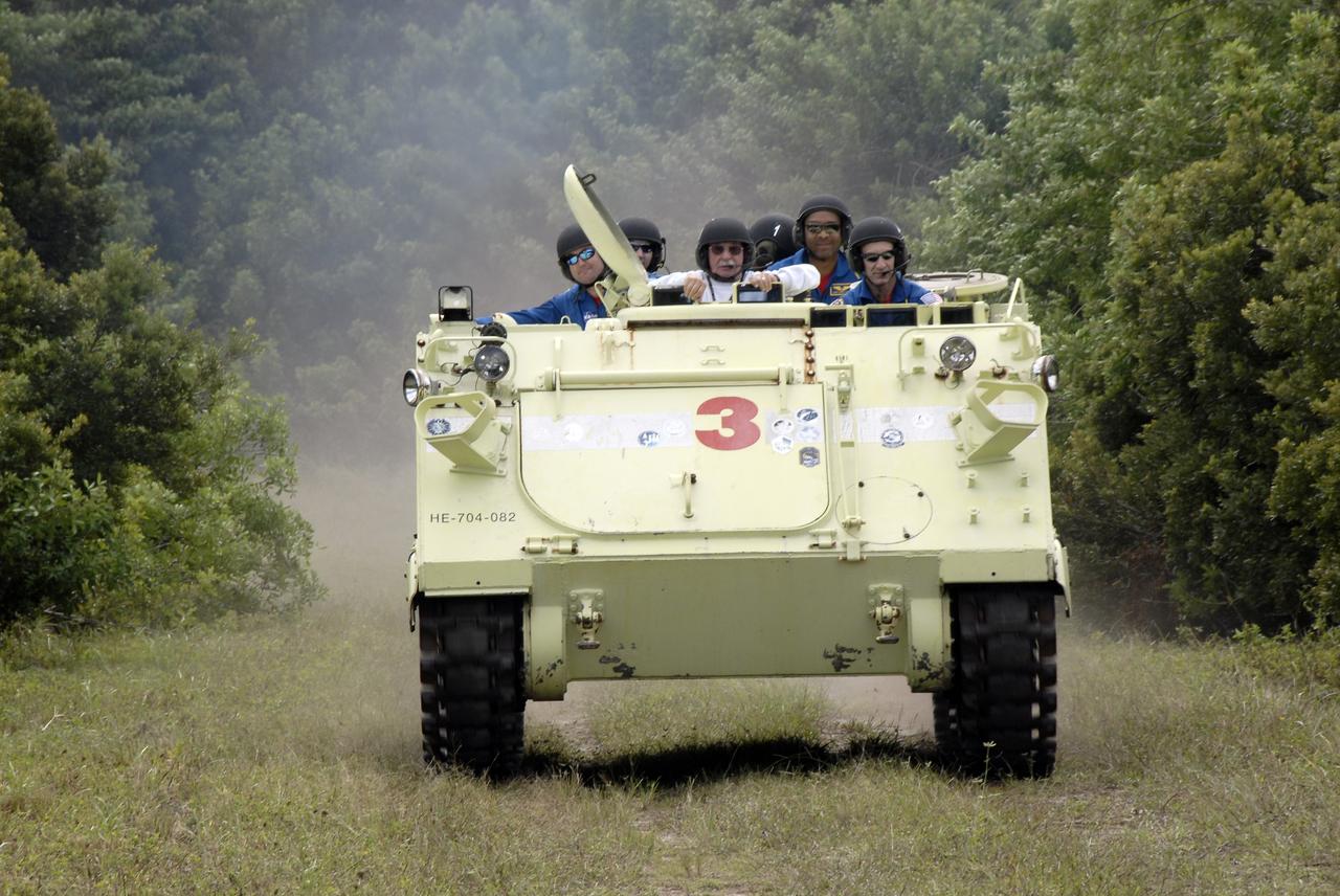 CAPE CANAVERAL, Fla. - At NASA's Kennedy Space Center in Florida, STS-129 Commander Charles O. Hobaugh, at right, takes his crew and instructor for a ride in an M113 armored personnel carrier during driving practice. Left of Hobaugh is the instructor, Battalion Chief George Hoggard.    The M113 is kept at the foot of the launch pad in case an emergency egress from the vicinity of the pad is needed.  The crew members of space shuttle Atlantis' STS-129 mission are at Kennedy for training related to their launch dress rehearsal, the Terminal Countdown Demonstration Test.  Launch of Atlantis on its STS-129 mission to the International Space Station is targeted for Nov. 16. For information on the STS-129 mission objectives and crew, visit http://www.nasa.gov/mission_pages/shuttle/shuttlemissions/sts129/index.html. Photo credit: NASA/Kim Shiflett