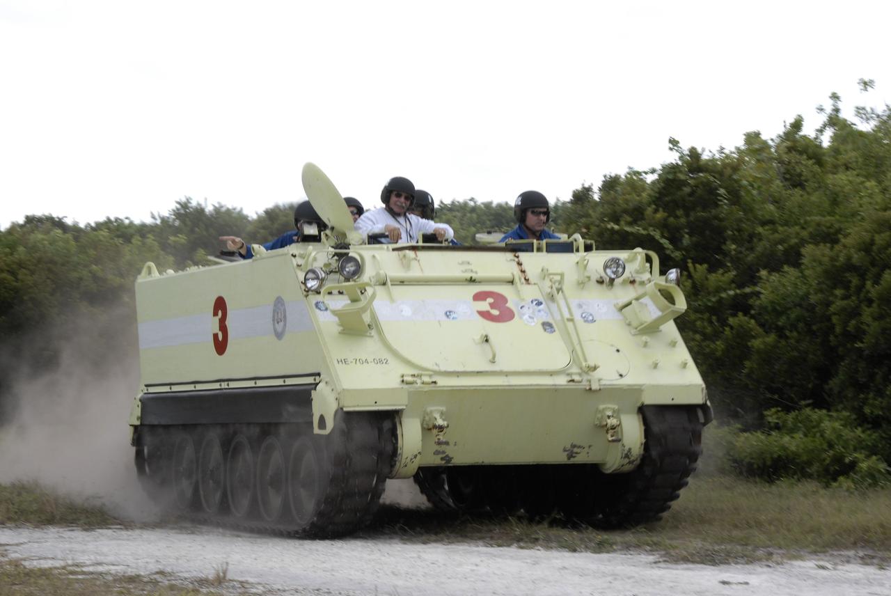 CAPE CANAVERAL, Fla. - At NASA's Kennedy Space Center in Florida, STS-129 Pilot Barry E. Wilmore, at right, takes his crew and instructor for a ride in an M113 armored personnel carrier during driving practice. Left of Wilmore is the instructor, Battalion Chief George Hoggard.    The M113 is kept at the foot of the launch pad in case an emergency egress from the vicinity of the pad is needed.  The crew members of space shuttle Atlantis' STS-129 mission are at Kennedy for training related to their launch dress rehearsal, the Terminal Countdown Demonstration Test.  Launch of Atlantis on its STS-129 mission to the International Space Station is targeted for Nov. 16. For information on the STS-129 mission objectives and crew, visit http://www.nasa.gov/mission_pages/shuttle/shuttlemissions/sts129/index.html. Photo credit: NASA/Kim Shiflett
