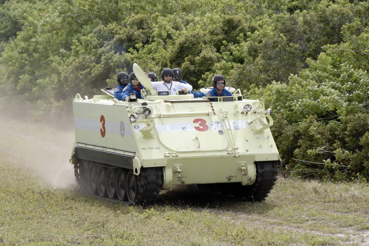 CAPE CANAVERAL, Fla. - At NASA's Kennedy Space Center in Florida, STS-129 Mission Specialist Mike Foreman, at right, takes his crew and instructor for a ride in an M113 armored personnel carrier during driving practice. Left of Wilmore is the instructor, Battalion Chief George Hoggard.    The M113 is kept at the foot of the launch pad in case an emergency egress from the vicinity of the pad is needed.  The crew members of space shuttle Atlantis' STS-129 mission are at Kennedy for training related to their launch dress rehearsal, the Terminal Countdown Demonstration Test.  Launch of Atlantis on its STS-129 mission to the International Space Station is targeted for Nov. 16. For information on the STS-129 mission objectives and crew, visit http://www.nasa.gov/mission_pages/shuttle/shuttlemissions/sts129/index.html. Photo credit: NASA/Kim Shiflett
