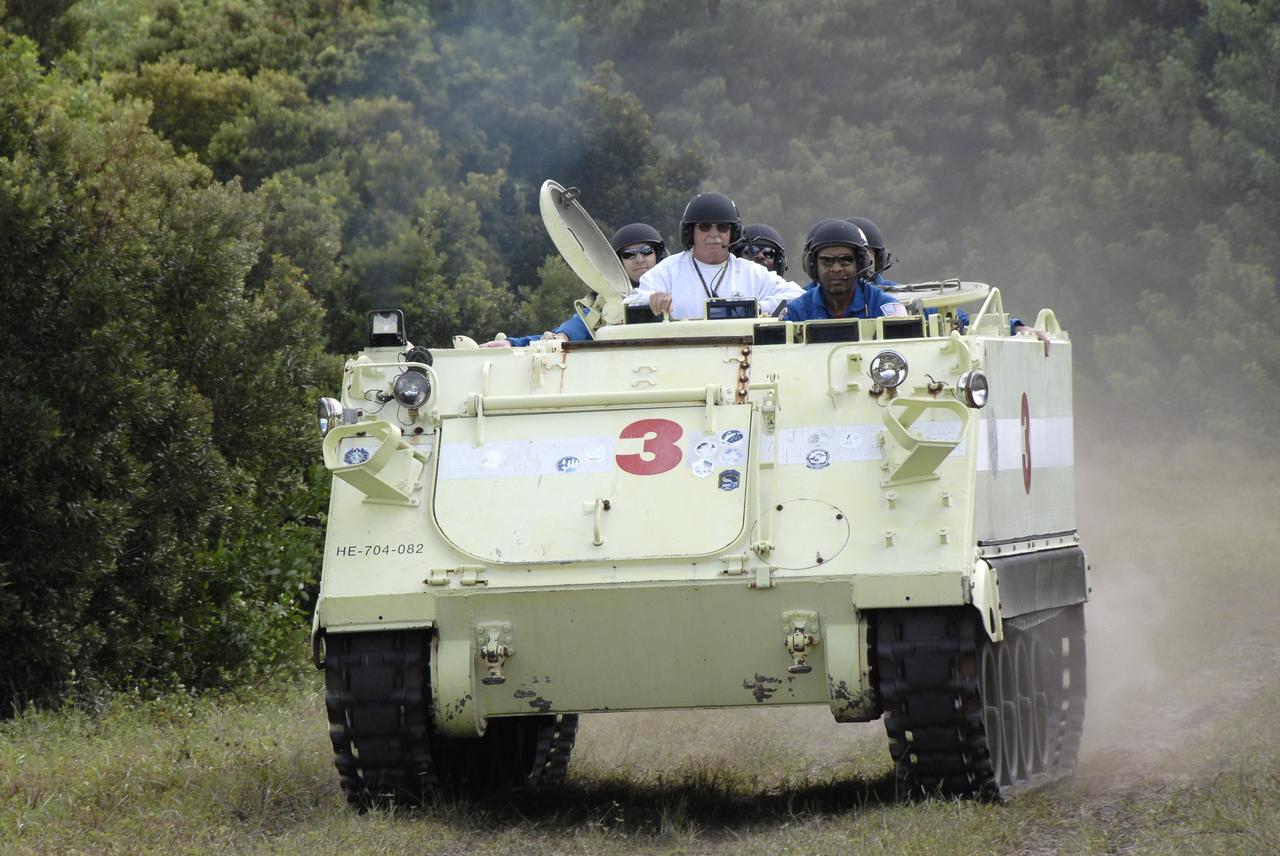 CAPE CANAVERAL, Fla. - At NASA's Kennedy Space Center in Florida, STS-129 Mission Specialist Robert L. Satcher Jr., at right, takes his crew and instructor for a ride in an M113 armored personnel carrier during driving practice. Left of Satcher is the instructor, Battalion Chief George Hoggard. The M113 is kept at the foot of the launch pad in case an emergency egress from the vicinity of the pad is needed. The crew members of space shuttle Atlantis' STS-129 mission are at Kennedy for training related to their launch dress rehearsal, the Terminal Countdown Demonstration Test. Launch of Atlantis on its STS-129 mission to the International Space Station is targeted for Nov. 16. For information on the STS-129 mission objectives and crew, visit http://www.nasa.gov/mission_pages/shuttle/shuttlemissions/sts129/index.html. Photo credit: NASA/Kim Shiflett