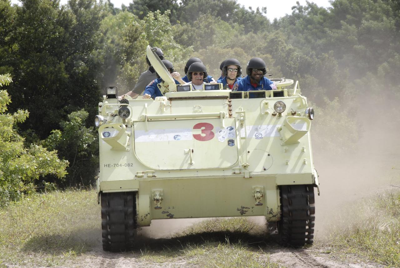 CAPE CANAVERAL, Fla. - At NASA's Kennedy Space Center in Florida, STS-129 Mission Specialist Leland Melvin, at right, takes his crew and instructor for a ride in an M113 armored personnel carrier during driving practice. Left of Satcher is the instructor, Battalion Chief George Hoggard, and Commander Charles O. Hobaugh.    The M113 is kept at the foot of the launch pad in case an emergency egress from the vicinity of the pad is needed.  The crew members of space shuttle Atlantis' STS-129 mission are at Kennedy for training related to their launch dress rehearsal, the Terminal Countdown Demonstration Test.  Launch of Atlantis on its STS-129 mission to the International Space Station is targeted for Nov. 16. For information on the STS-129 mission objectives and crew, visit http://www.nasa.gov/mission_pages/shuttle/shuttlemissions/sts129/index.html. Photo credit: NASA/Kim Shiflett